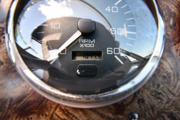 Close-up of 1997 Sea Ray 400 Sundancer RPM gauge showing 1011 hours.