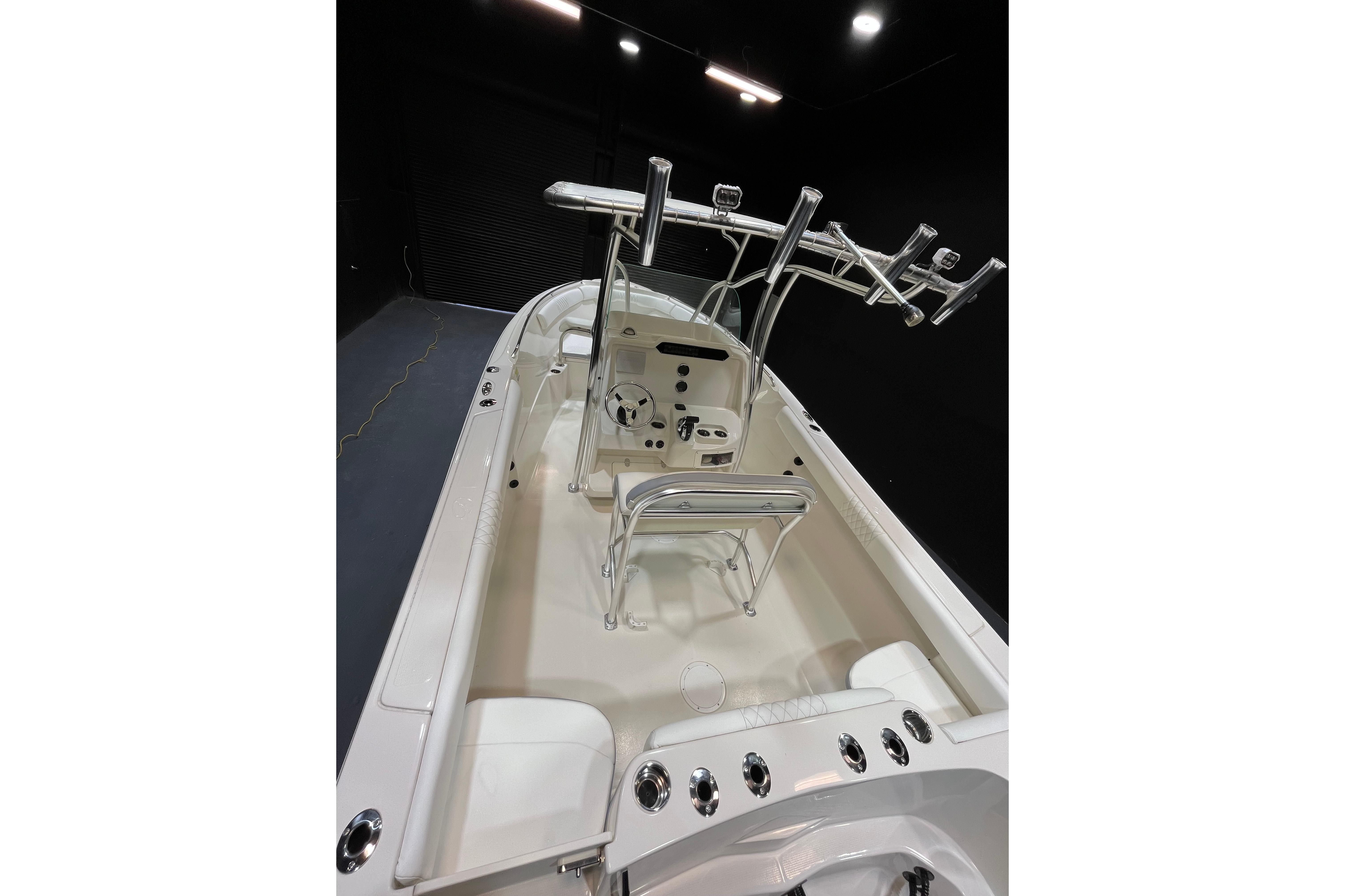 2022 Sailfish 242 CC boat interior with helm station and rod holders.