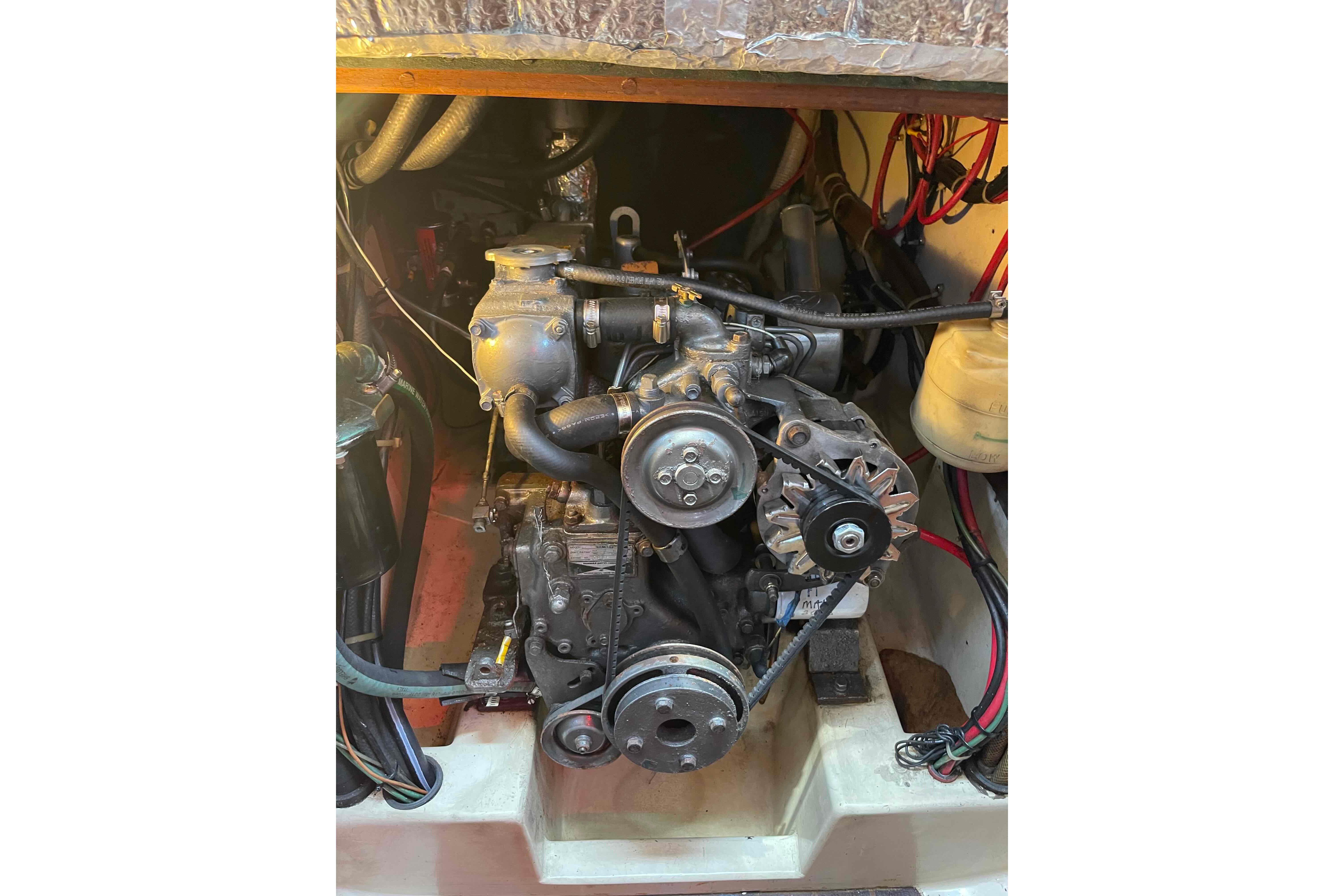 Engine compartment of a 1987 Pacific Seacraft 34 sailboat, showcasing mechanical components.
