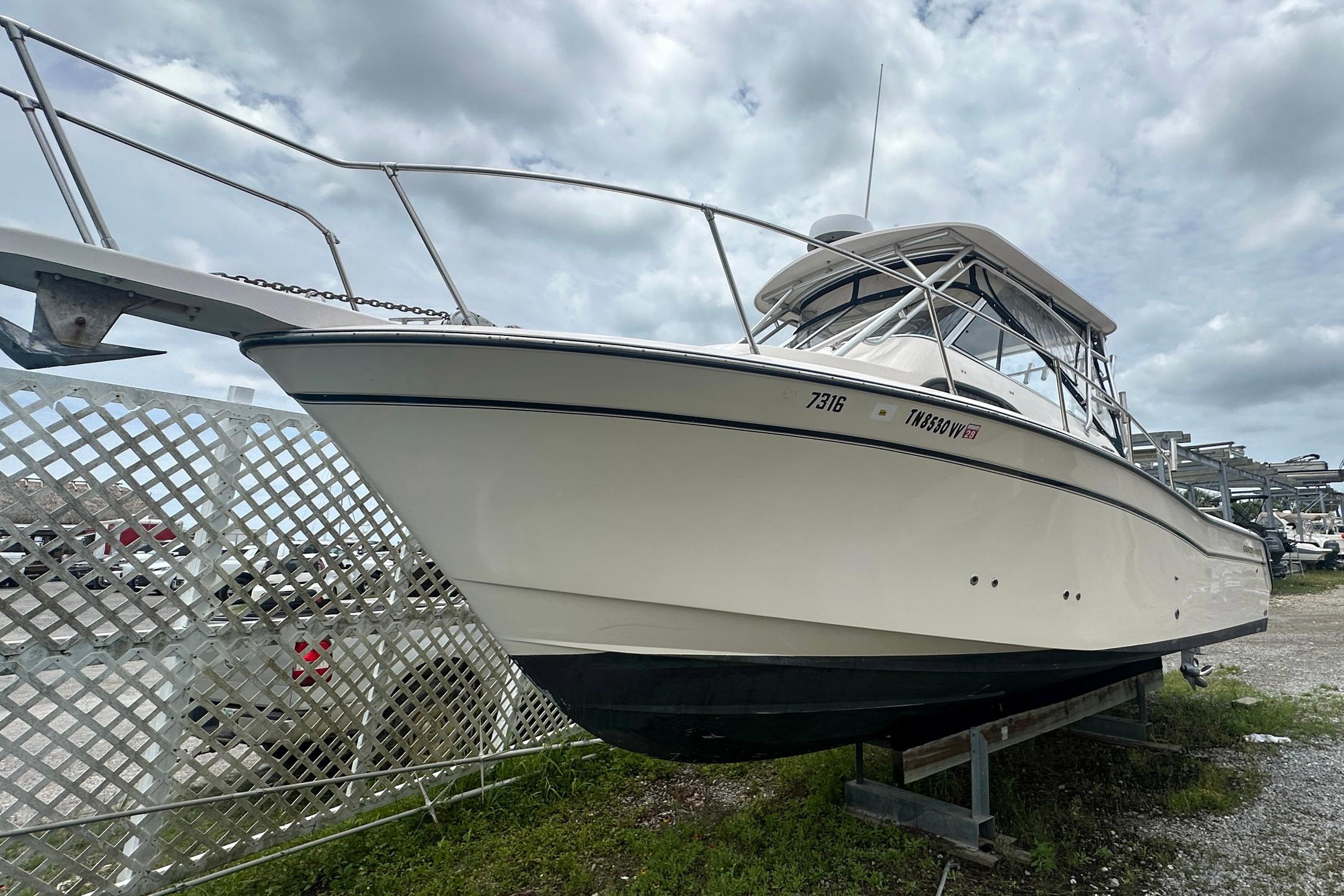 2006 Grady-White Marlin 300 boat on display under cloudy skies.
