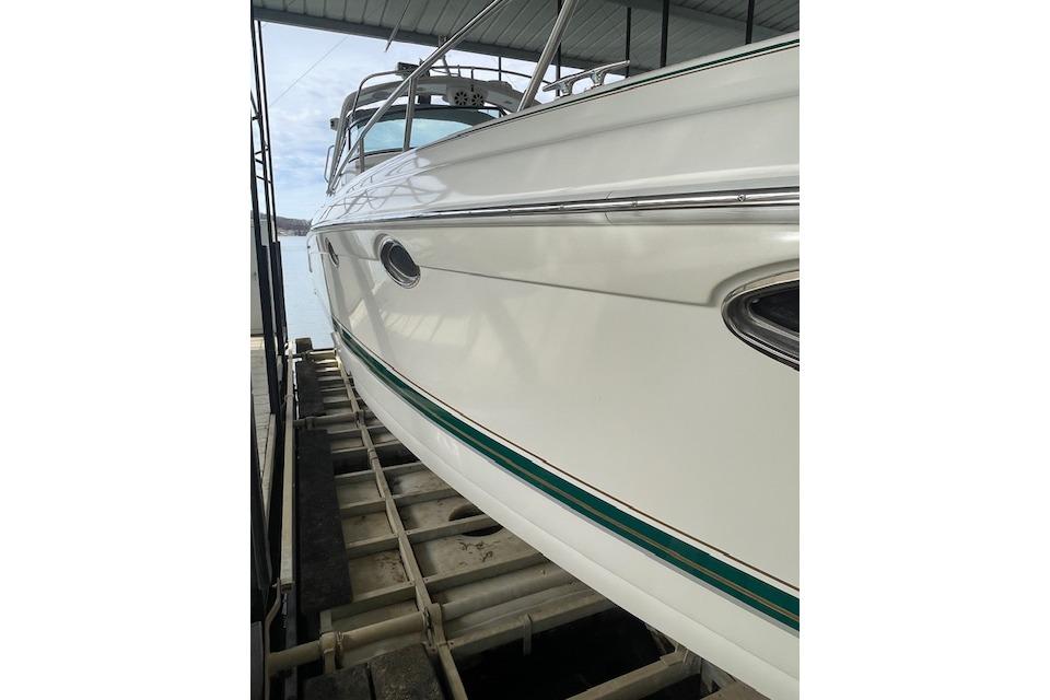 1999 Formula 400 Super Sport boat on a lift, showcasing sleek white hull design.