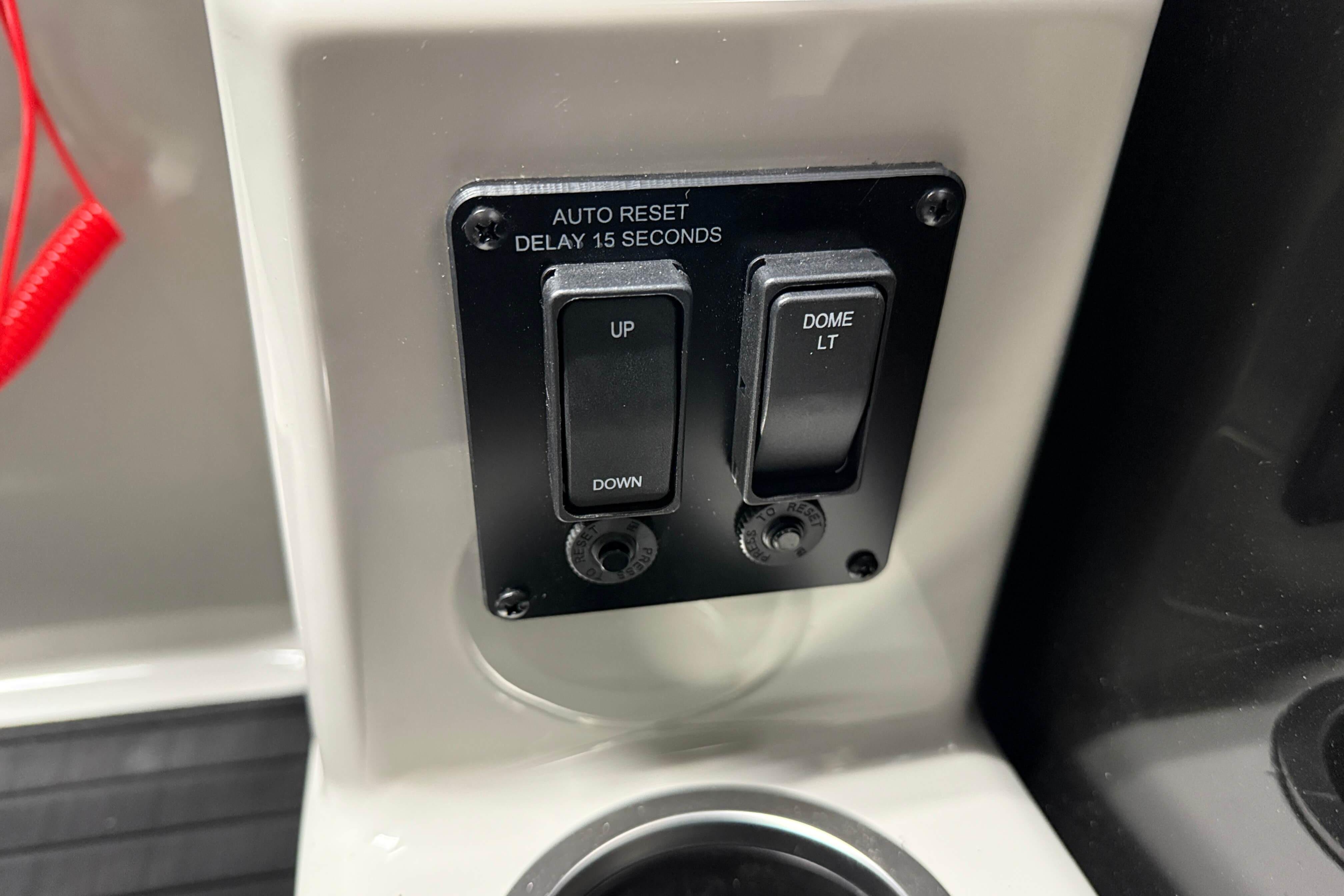 Control panel of 2026 Sylvan Mirage X1 with switches for dome light and auto reset.