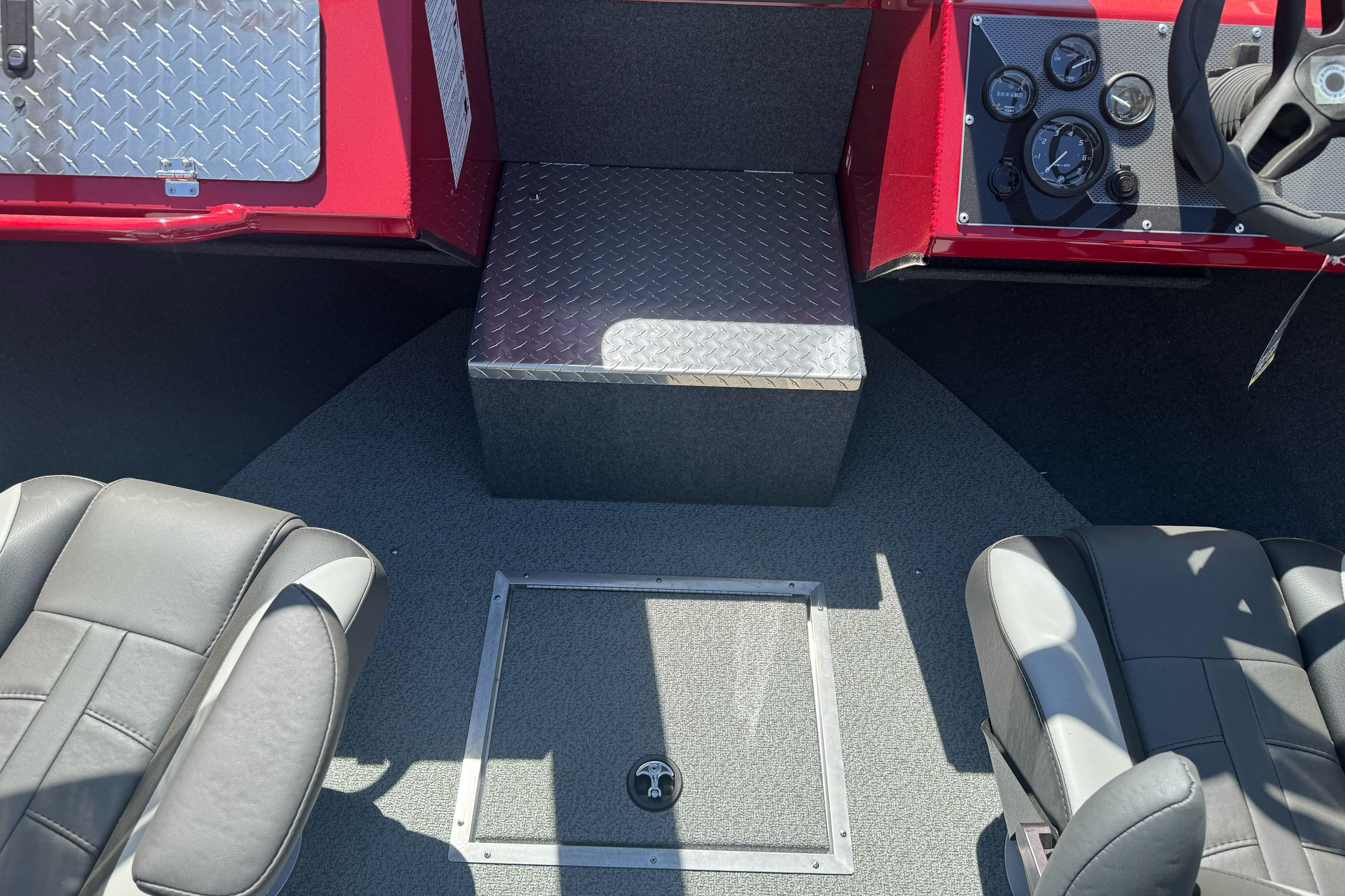 Interior of 2026 Lund 210 Heavy Gauge boat with seating and control panel.