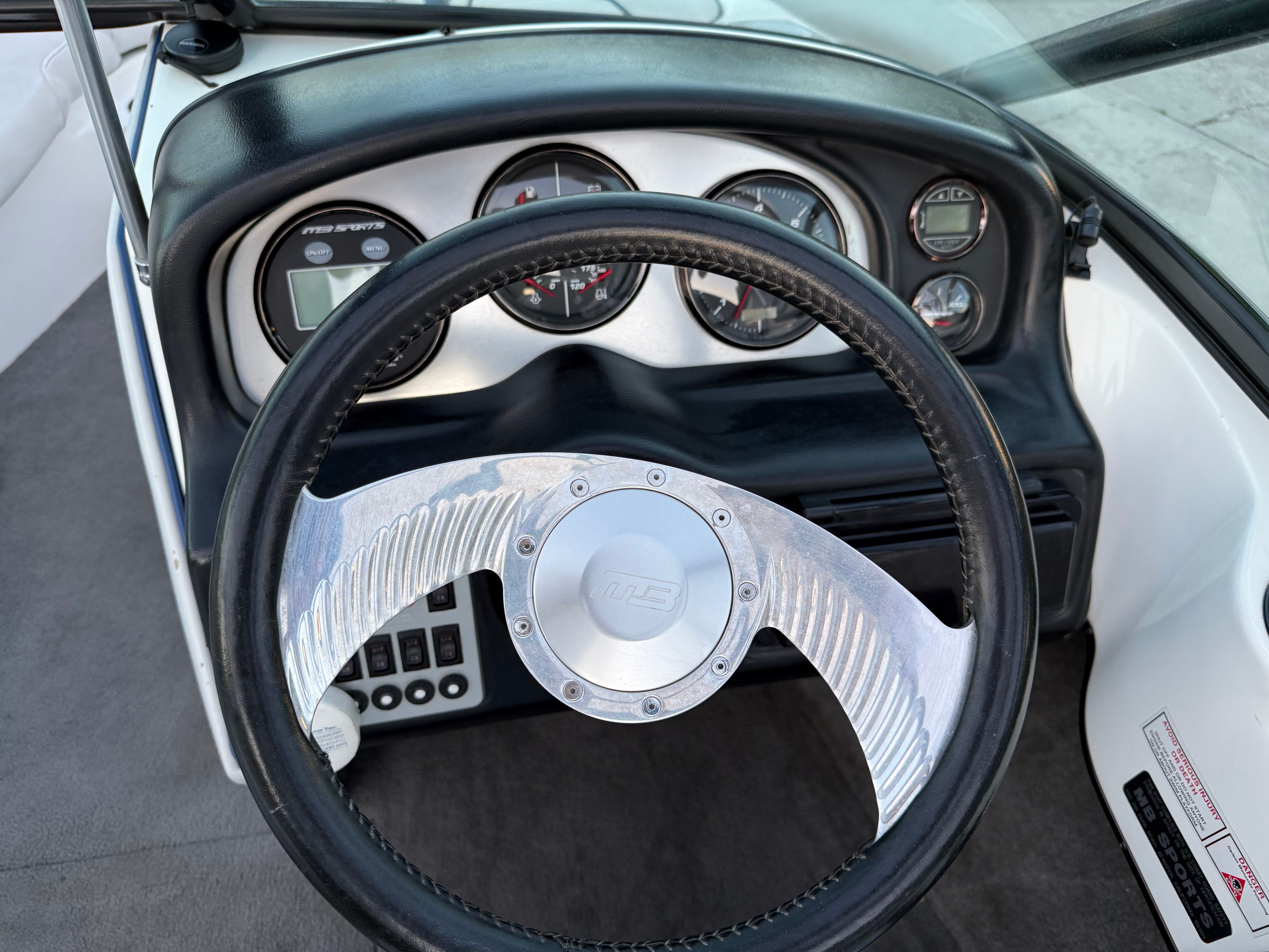 Steering wheel and dashboard of a 2004 MB Sports 220 boat.