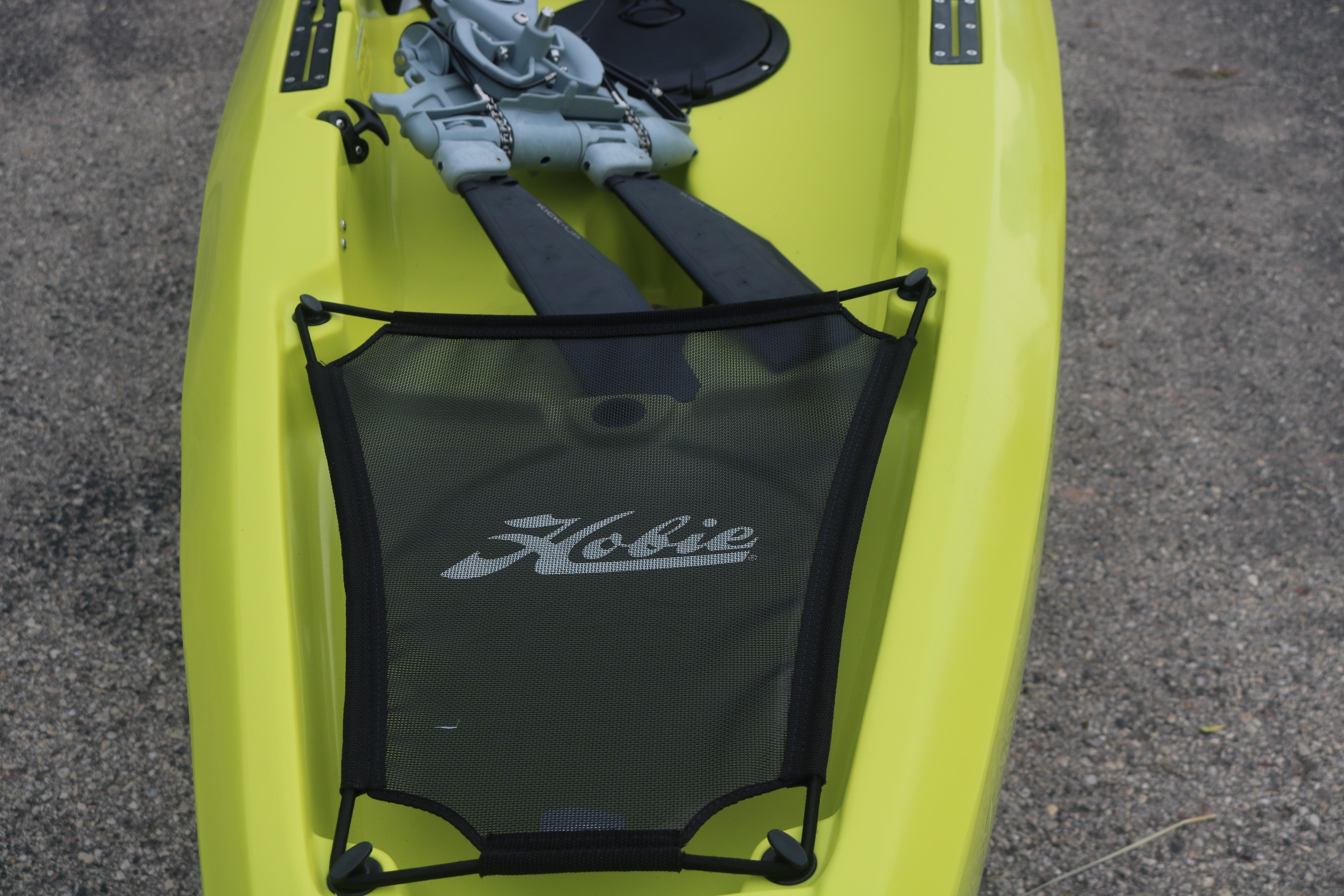 Yellow 2025 Hobie Mirage Compass kayak with pedal drive system on gravel surface.