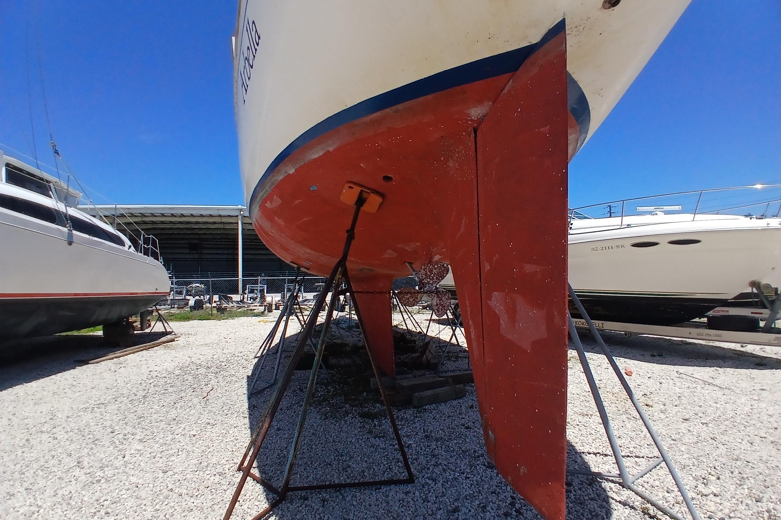 1981 Kaufman Skye 51 sailboat on stands, hull view, in a boatyard.