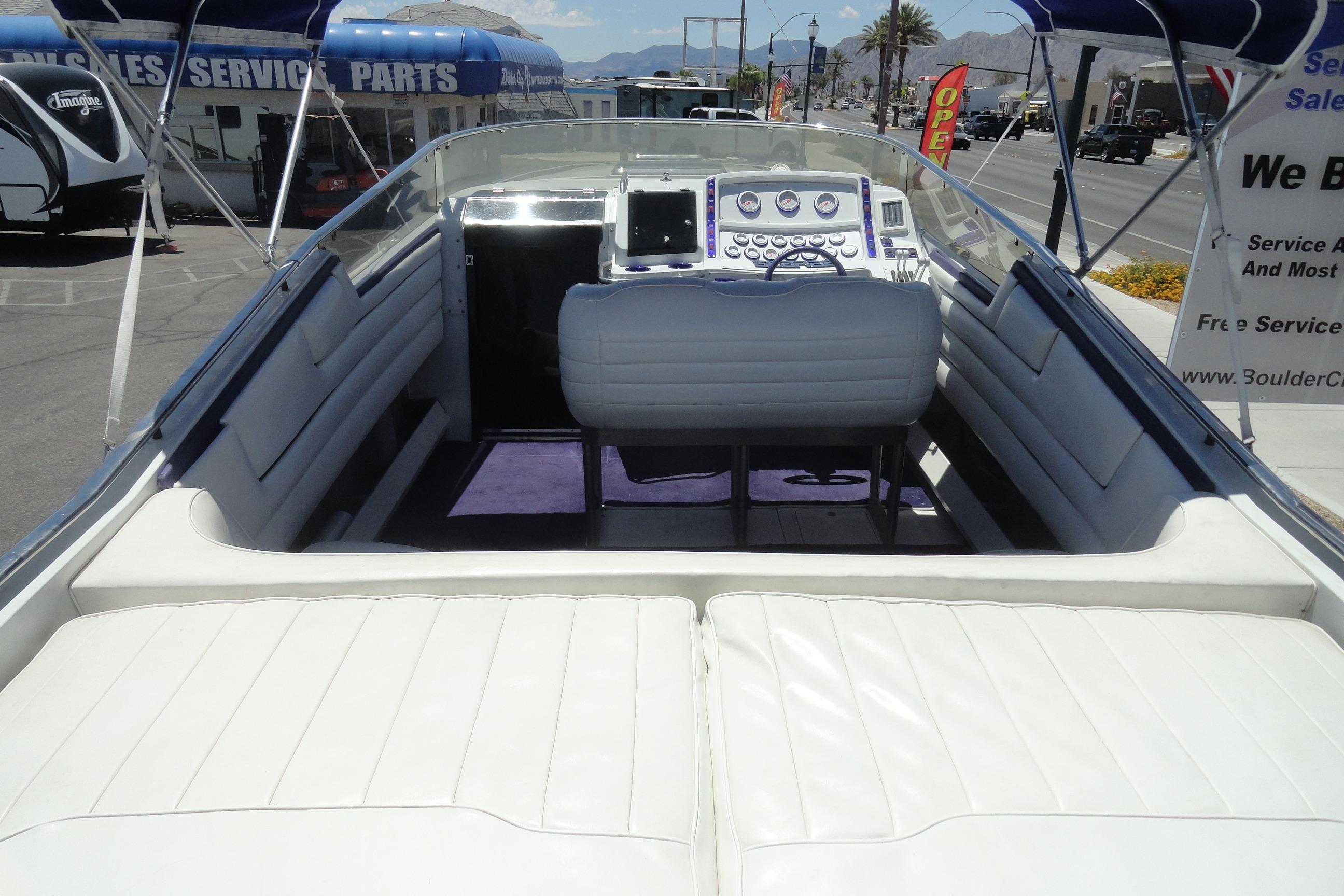 1988 Wellcraft 34 Scarab boat interior with white seating and control panel.