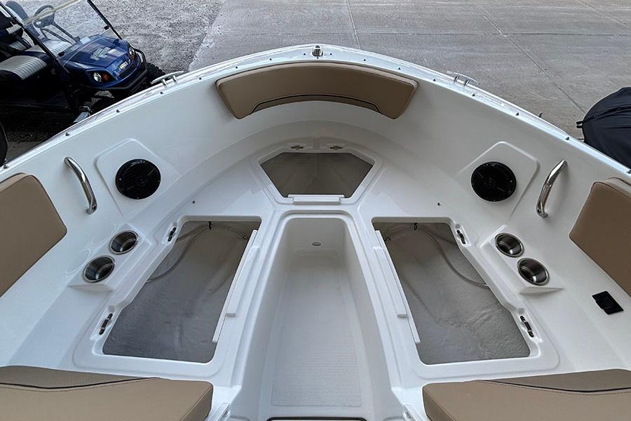 2026 Bayliner V20i boat interior with seating, cup holders, and speakers.