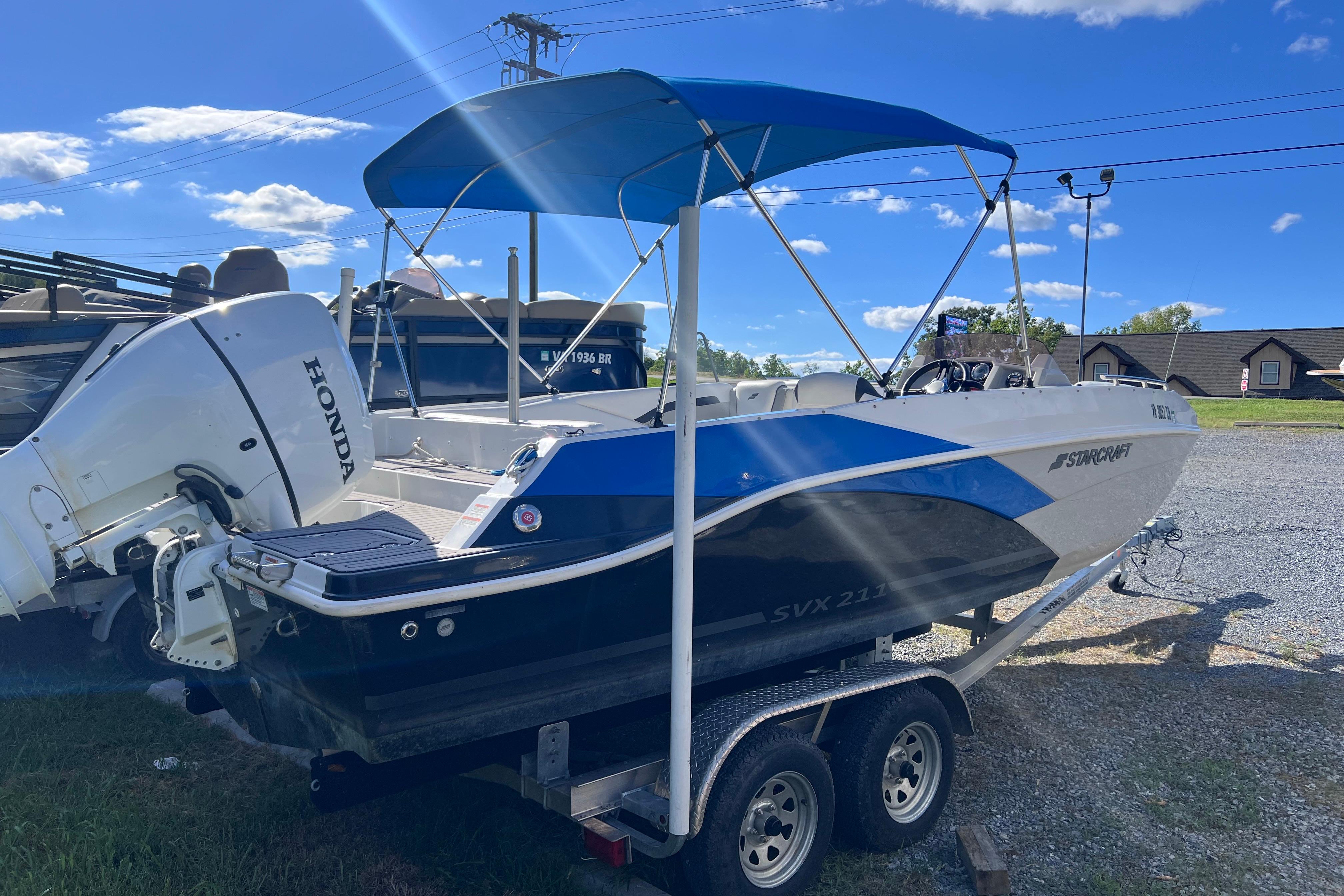 2021 Starcraft SVX 211 OB boat with Honda outboard motor on a trailer.