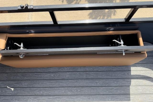 2026 Ranger 223F boat storage compartment with open lid, showcasing interior space and secure latches.