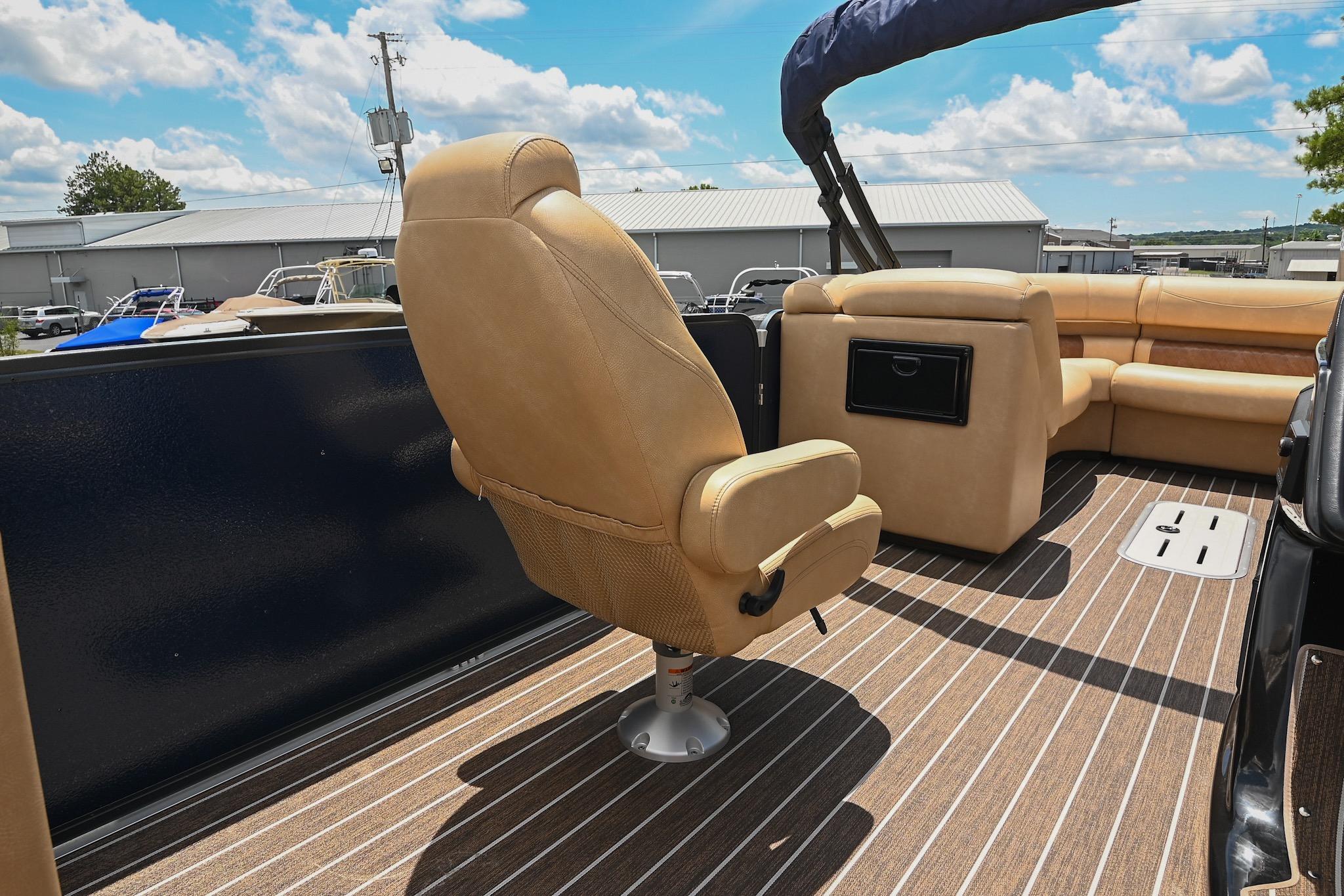 2023 Premier 270 Intrigue RF boat interior with tan seating and striped flooring.