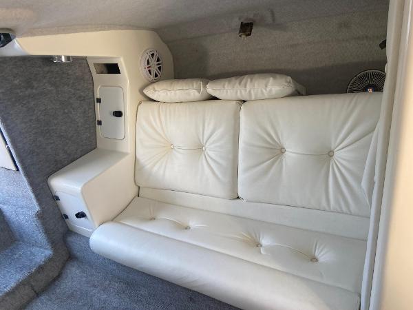Luxurious white leather seating in 2002 Advantage Victory boat interior.