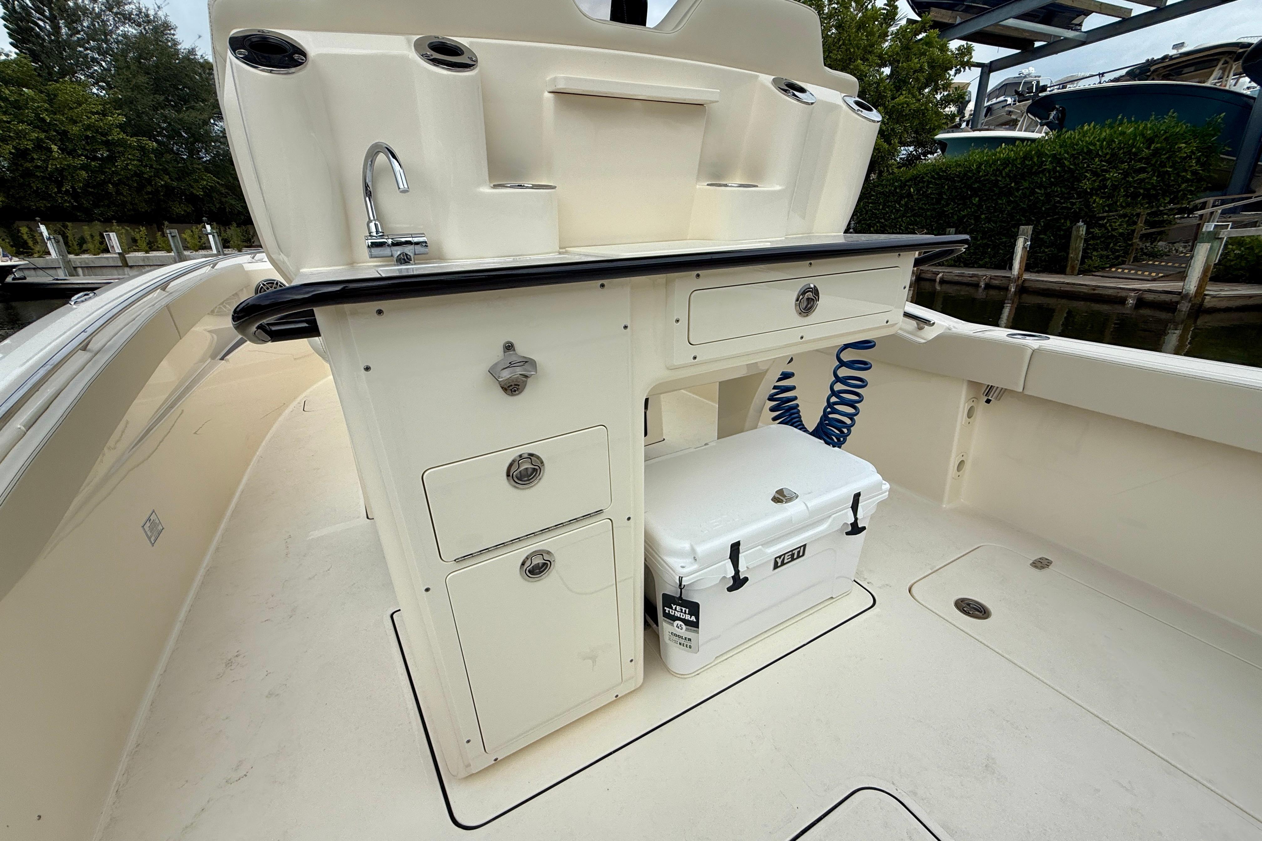 2026 Scout 288 LXF boat interior with sink, storage, and Yeti cooler.