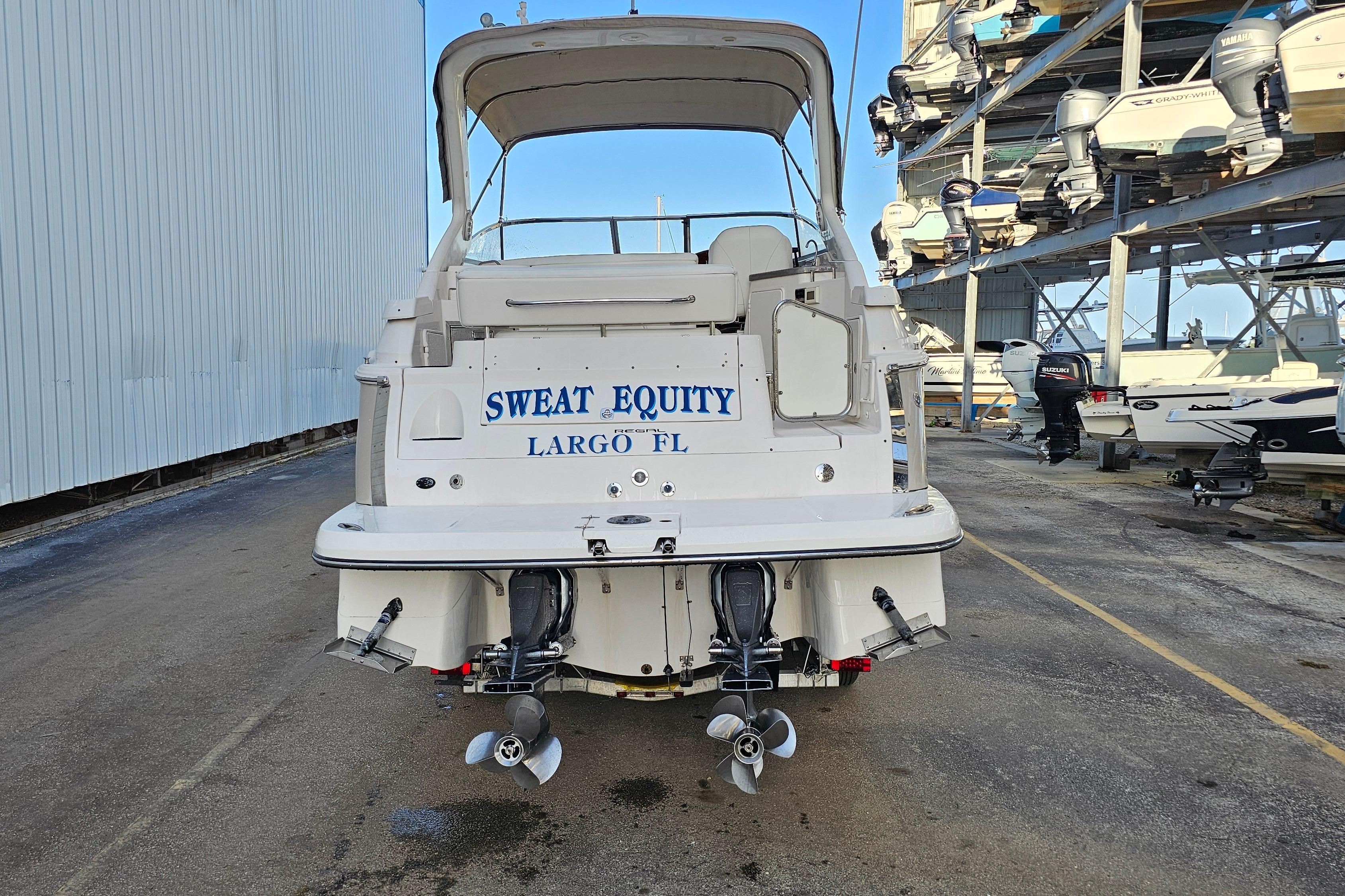 2005 Regal 3060 Window Express boat in marina, labeled "Sweat Equity" from Largo, FL.