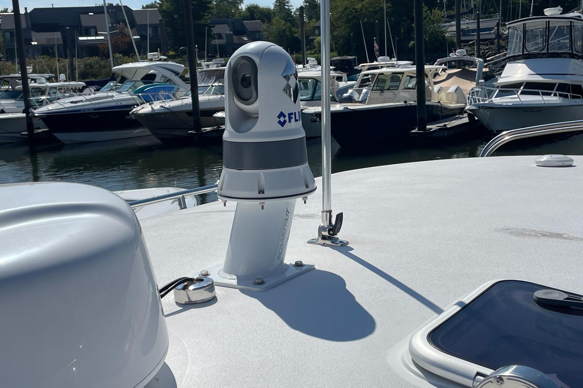 2023 MJM 35 boat with FLIR camera, docked in a marina.