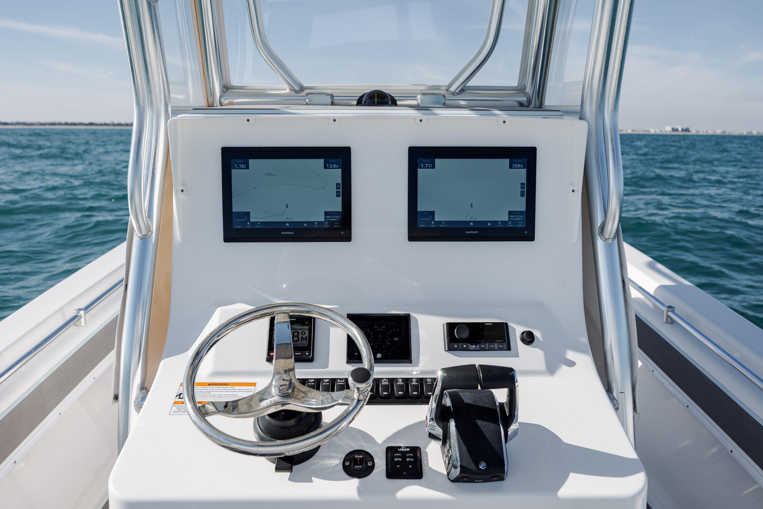 2024 Contender 28 Tournament boat dashboard with dual navigation screens on open water.