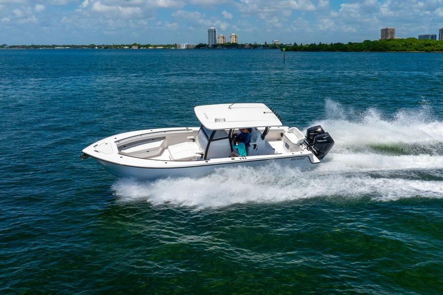 2027 Reef Runner 340 boat cruising on blue ocean waters under a clear sky.
