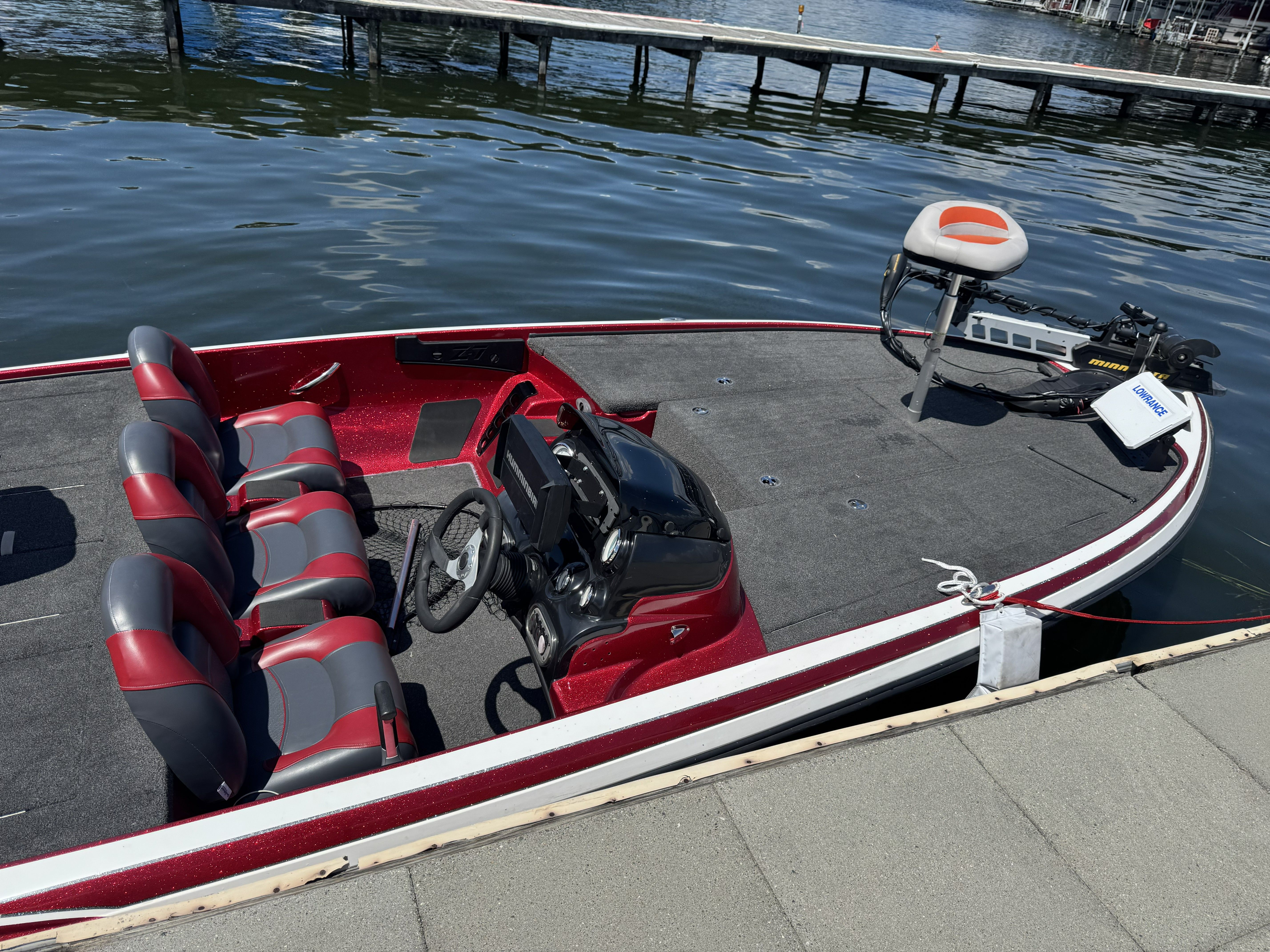 2014 Nitro Z71 boat docked with red seats.