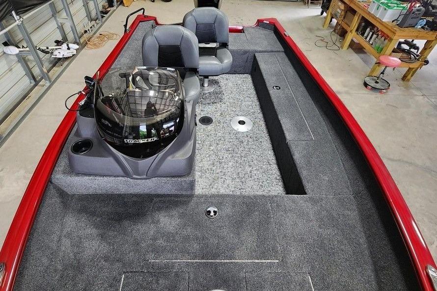 2026 Tracker Super Guide V-16 SC boat interior with gray seating and red trim.