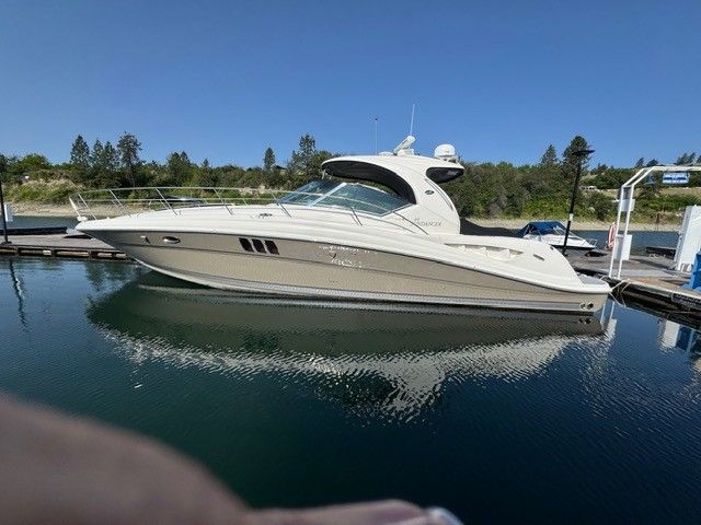 2006 Sea Ray 44 Sundancer on calm water at dock.