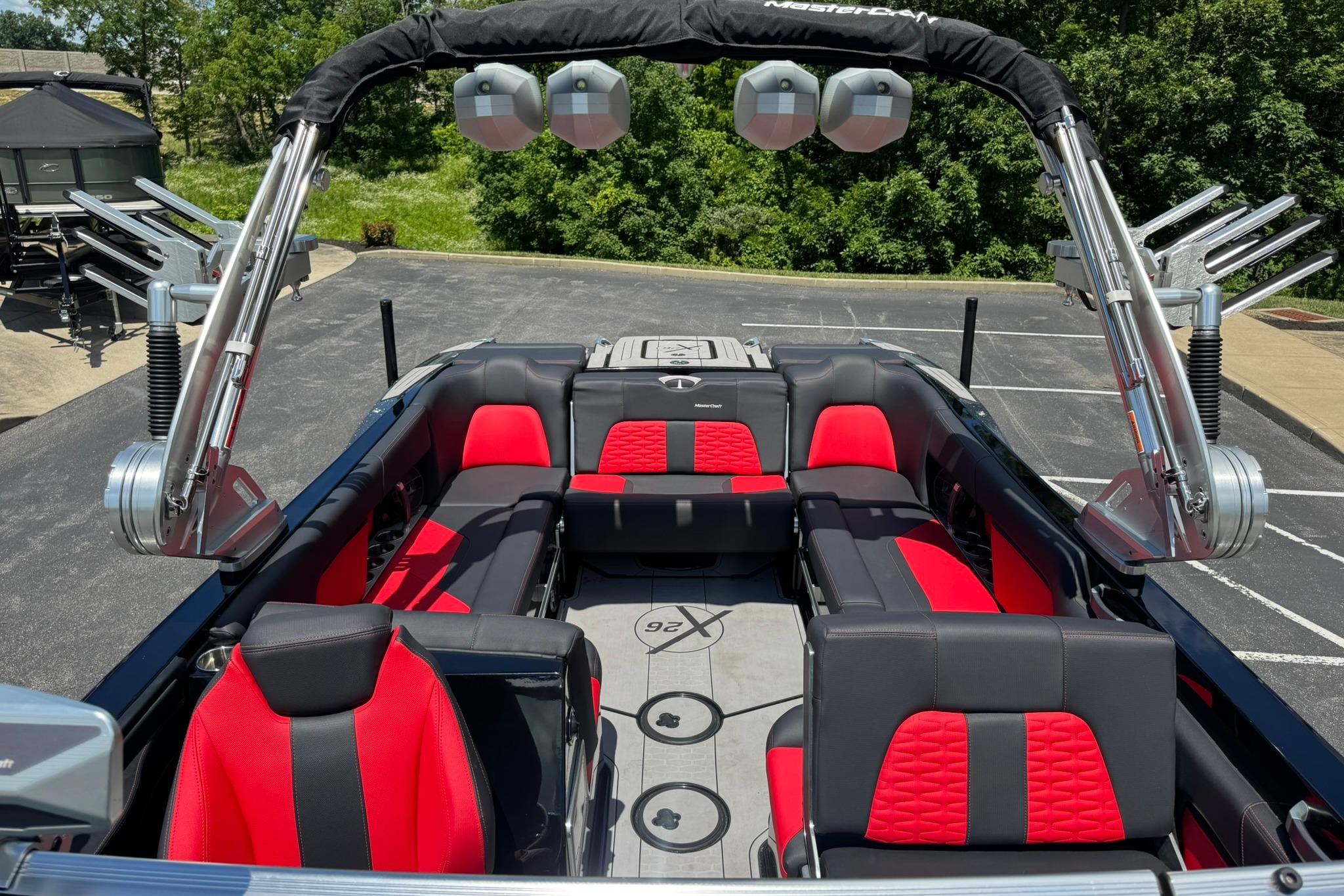 2021 MasterCraft X26 boat interior with red and black seating, sleek design, and advanced features.