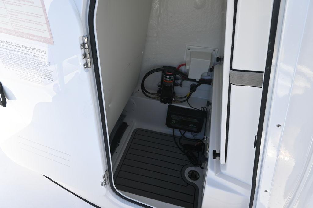 2026 Tidewater 2500 Carolina Bay boat storage compartment with electrical components and wiring.