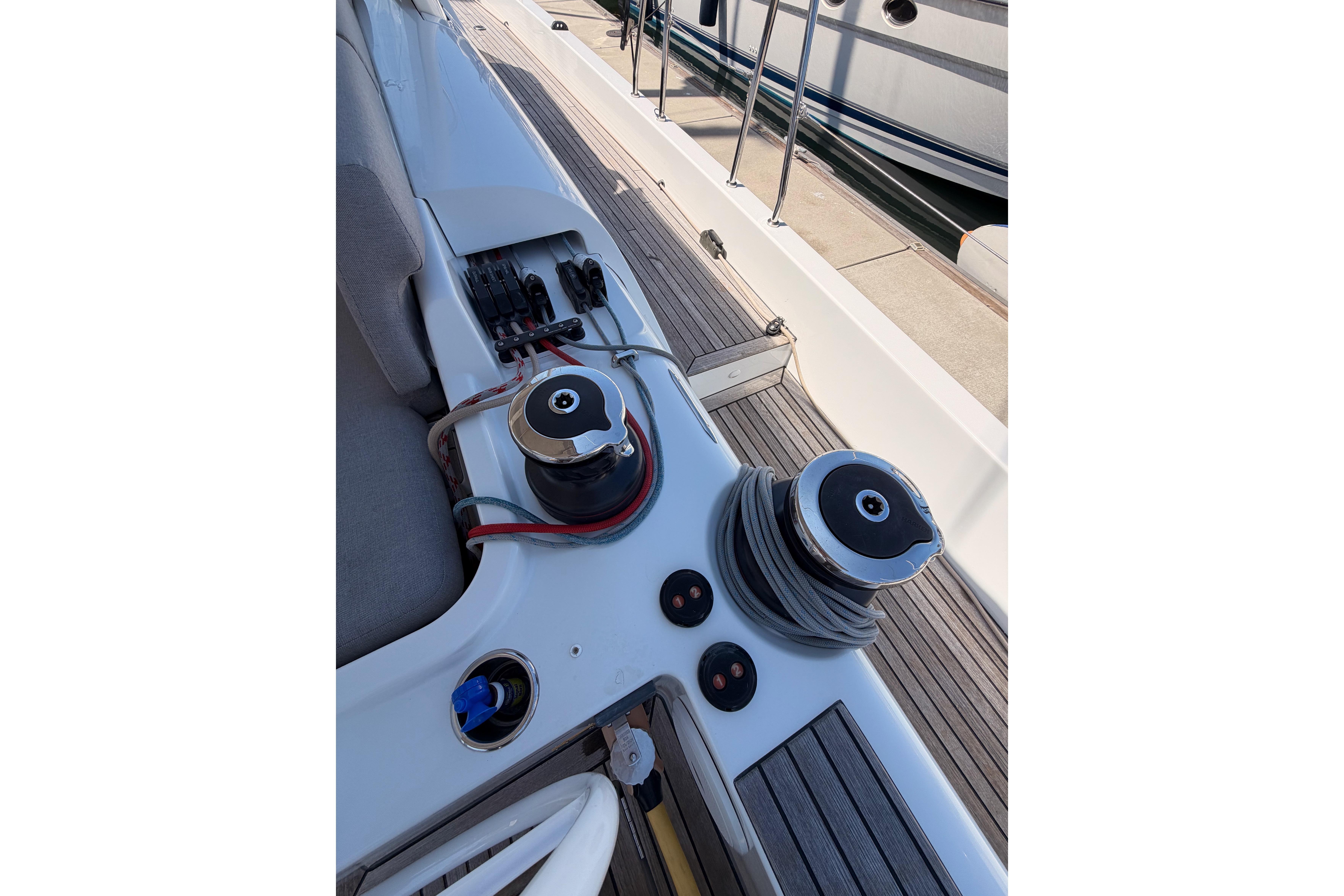Deck view of 2022 Beneteau Oceanis Yacht 54, featuring winches and teak flooring.