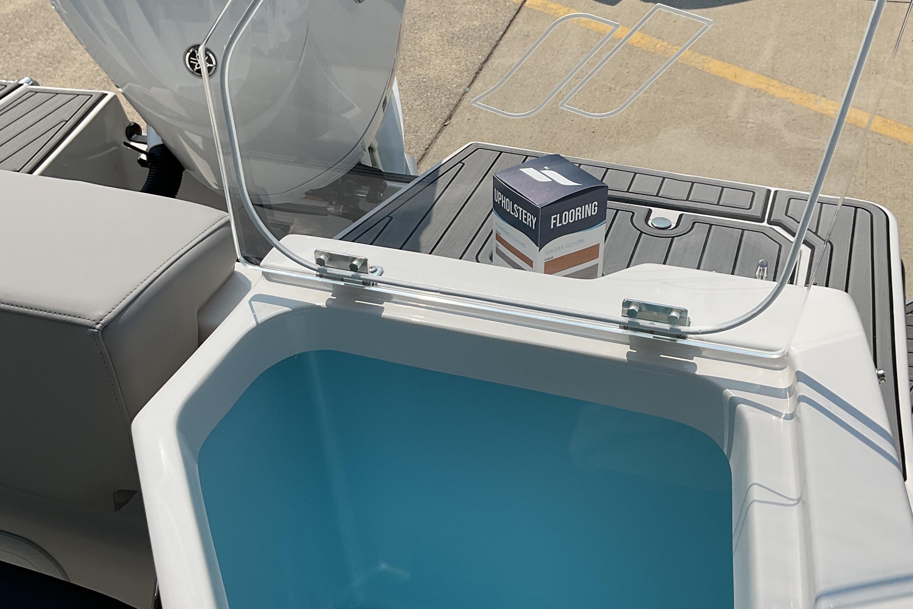 2026 Starcraft SVX 231 OB CC boat interior with open storage compartment and flooring box.