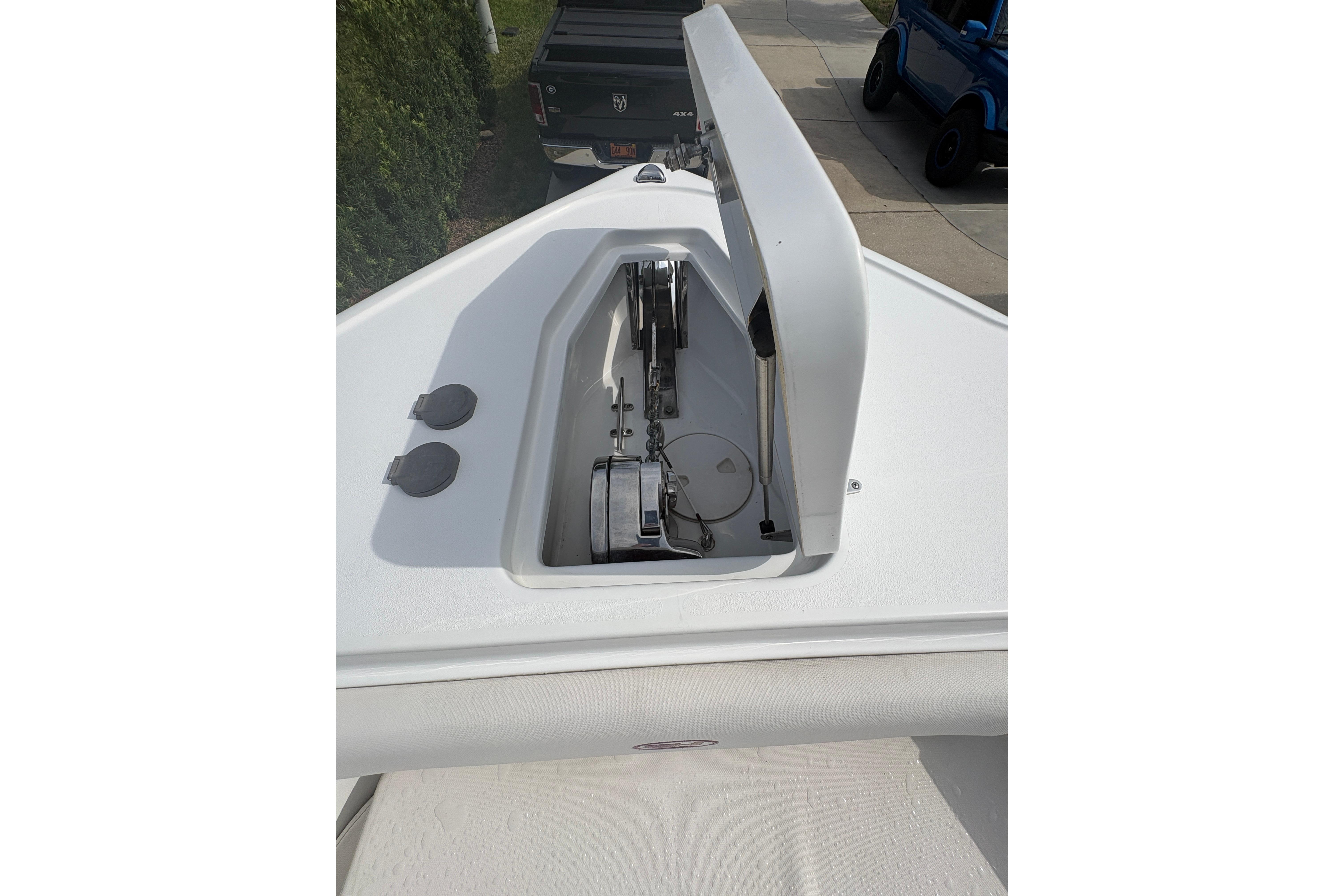 2021 Sea Hunt Ultra 265 SE boat anchor compartment open, showcasing storage space.