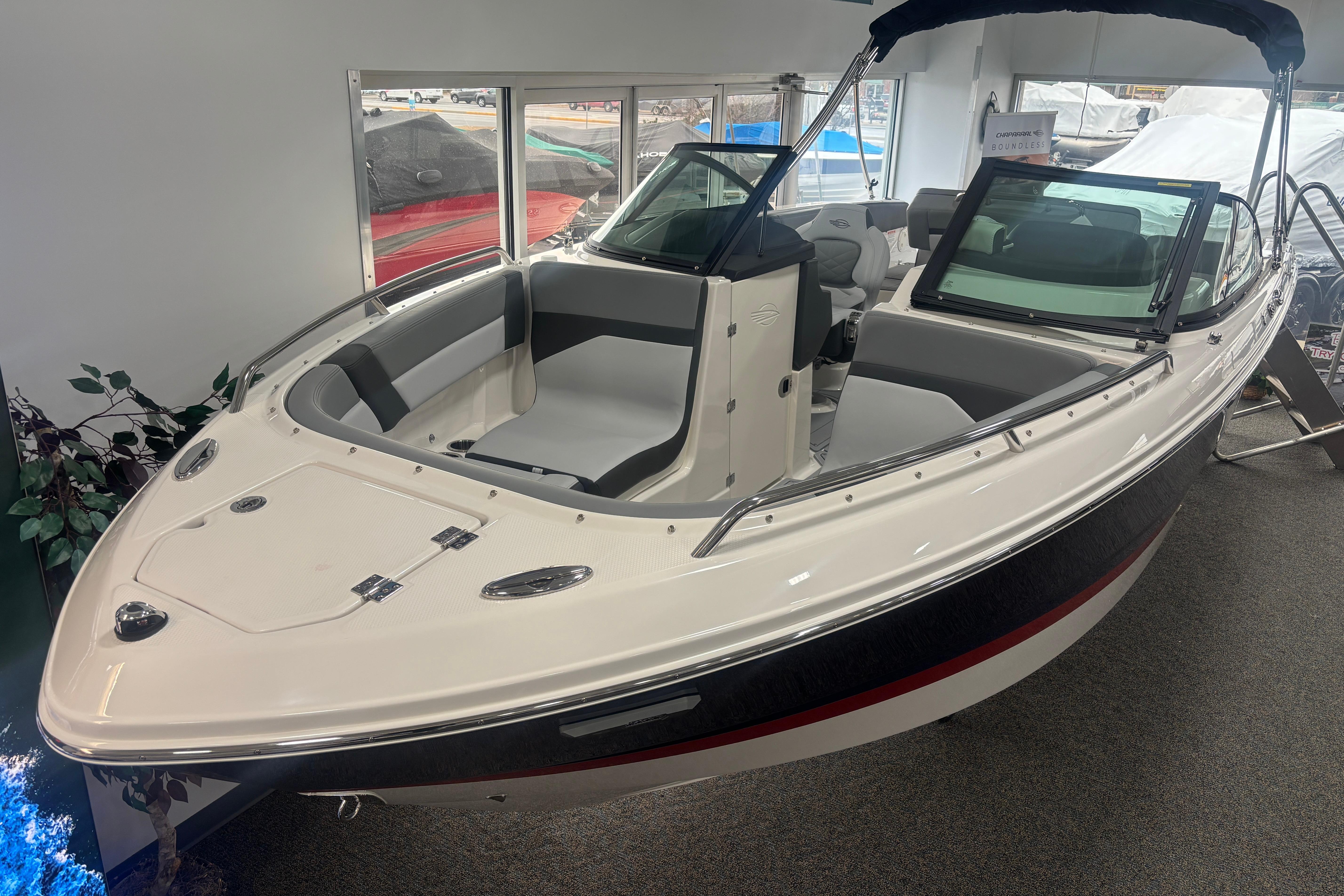 2026 Chaparral SSX 4 boat displayed indoors, featuring sleek design and spacious seating.