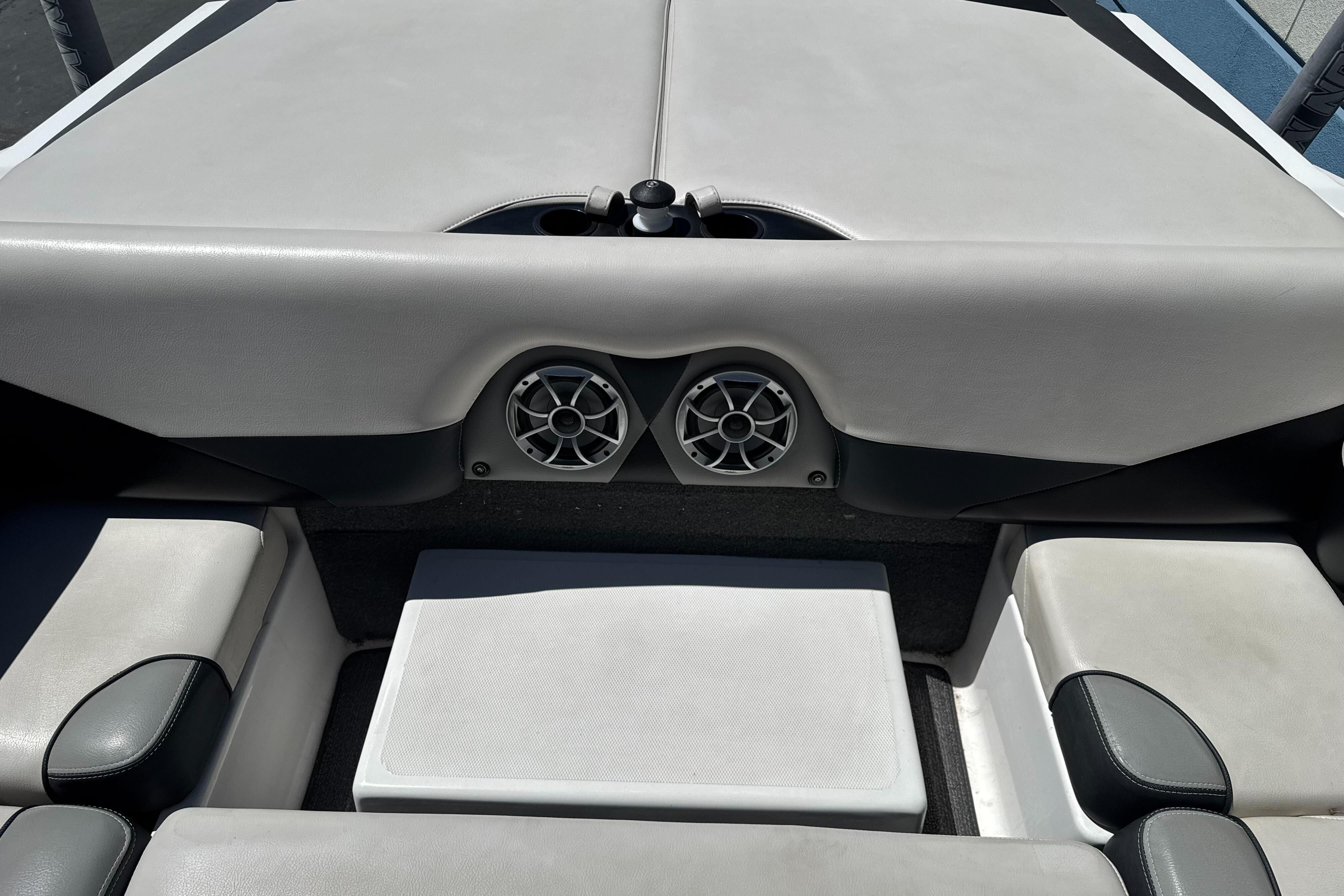 Interior of a 2015 Axis A20 boat featuring seating and built-in speakers.