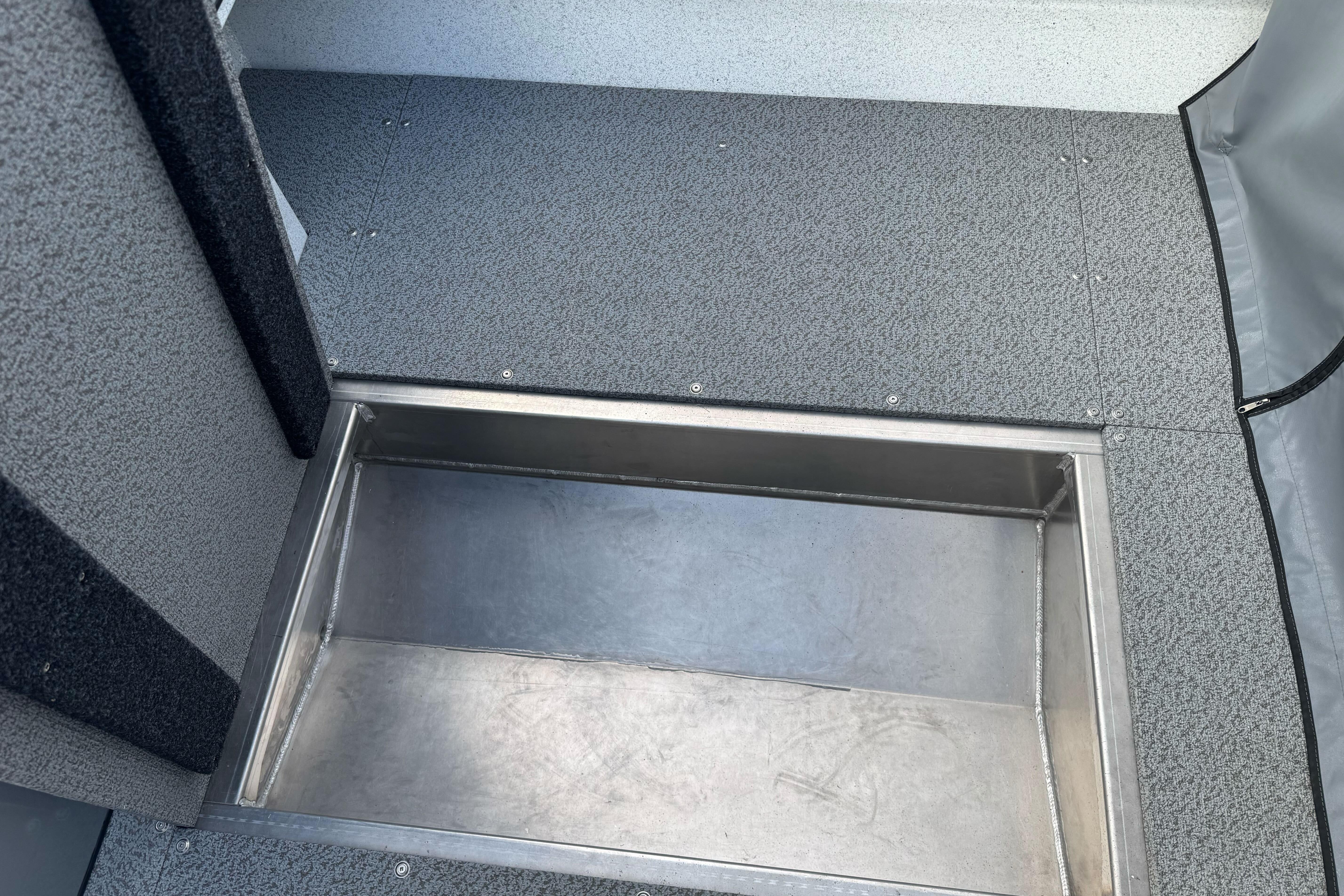 Interior view of 2026 KingFisher 2025 Escape boat, featuring a built-in storage compartment.
