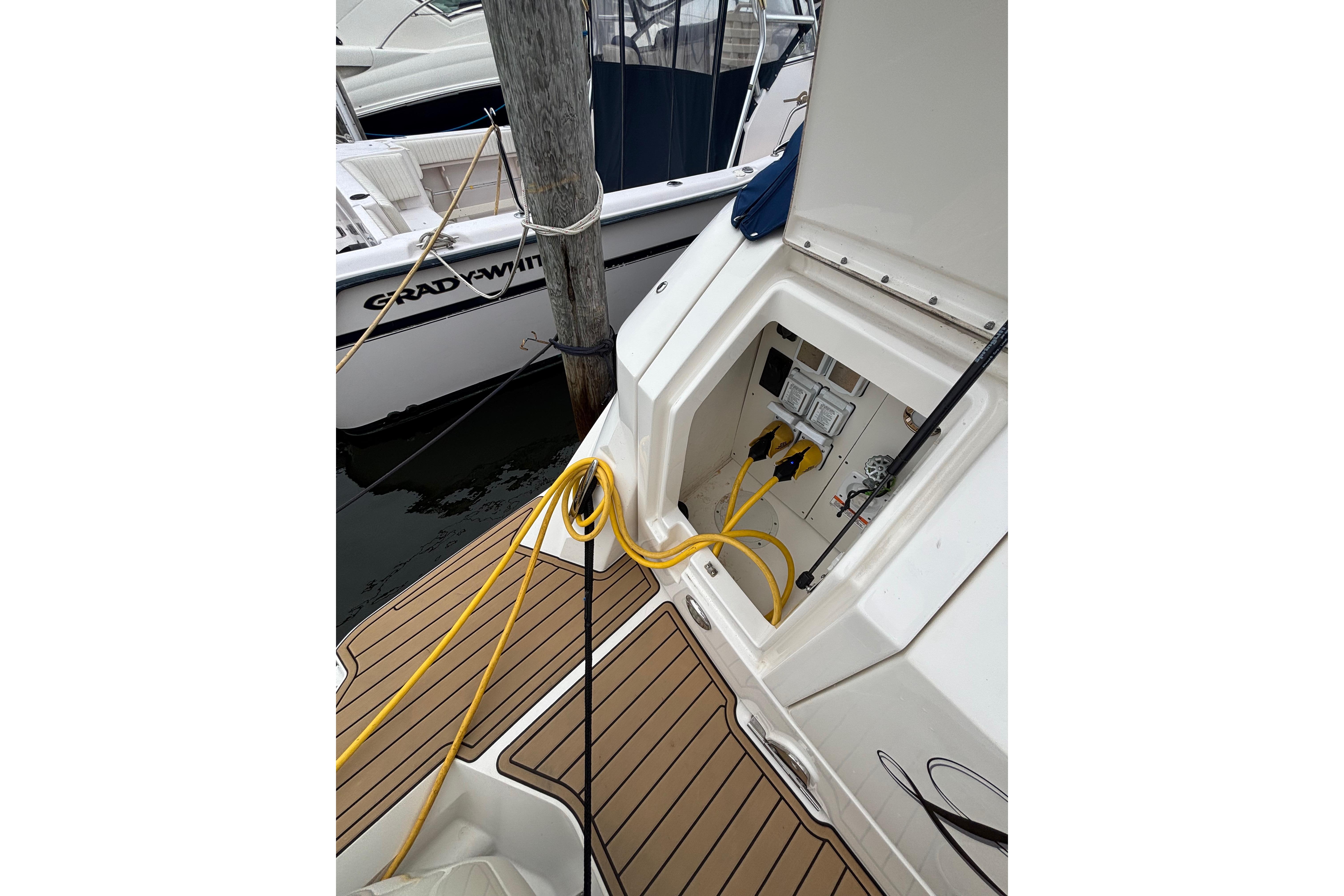 2021 Sea Ray Sundancer 320 Outboard with open hatch and yellow cables on deck.