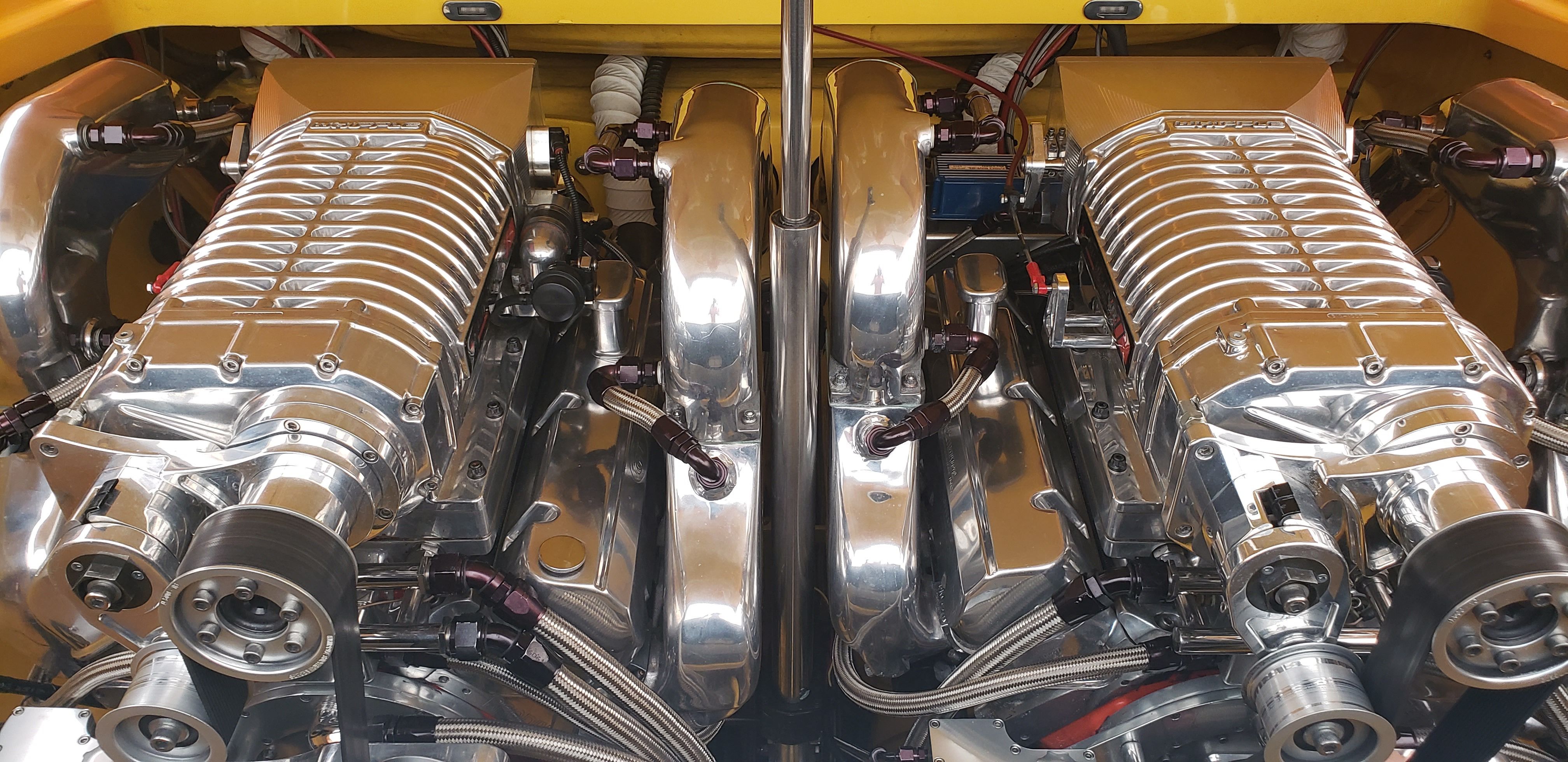 Dual engines of a 2009 Hallett 400T boat, shiny and powerful.