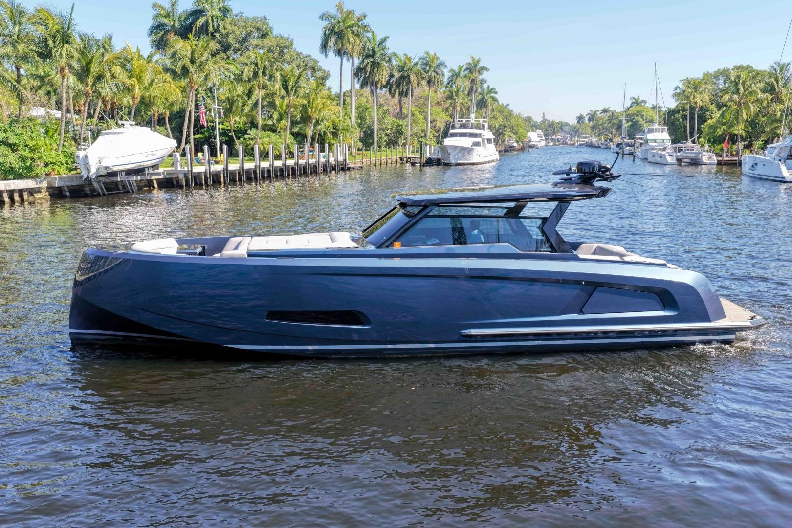 2022 Vanquish Yachts VQ45 luxury yacht cruising on a scenic waterway.