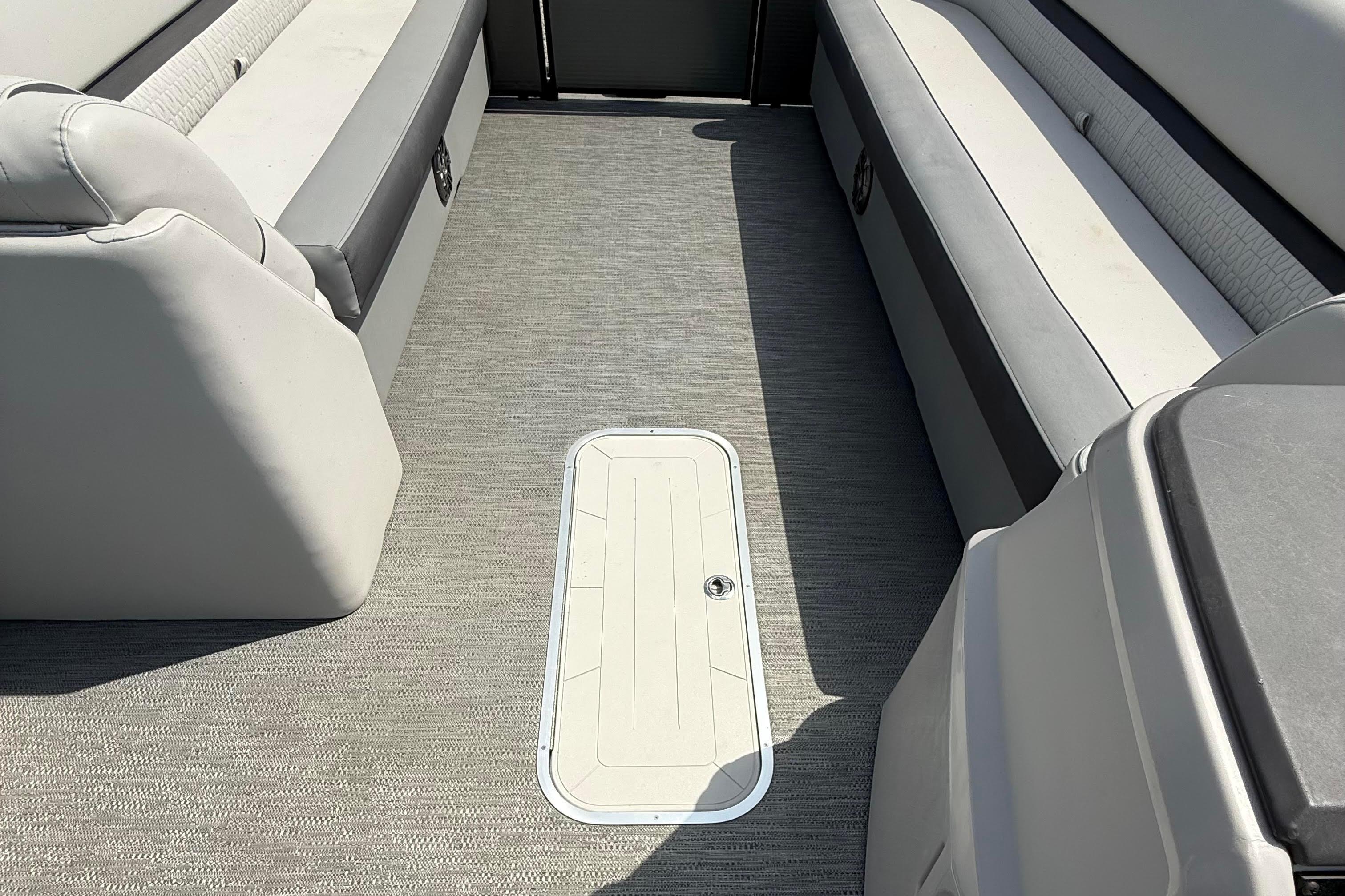 Interior of 2022 Godfrey SWEETWATER 2486 pontoon boat with gray seating and flooring.