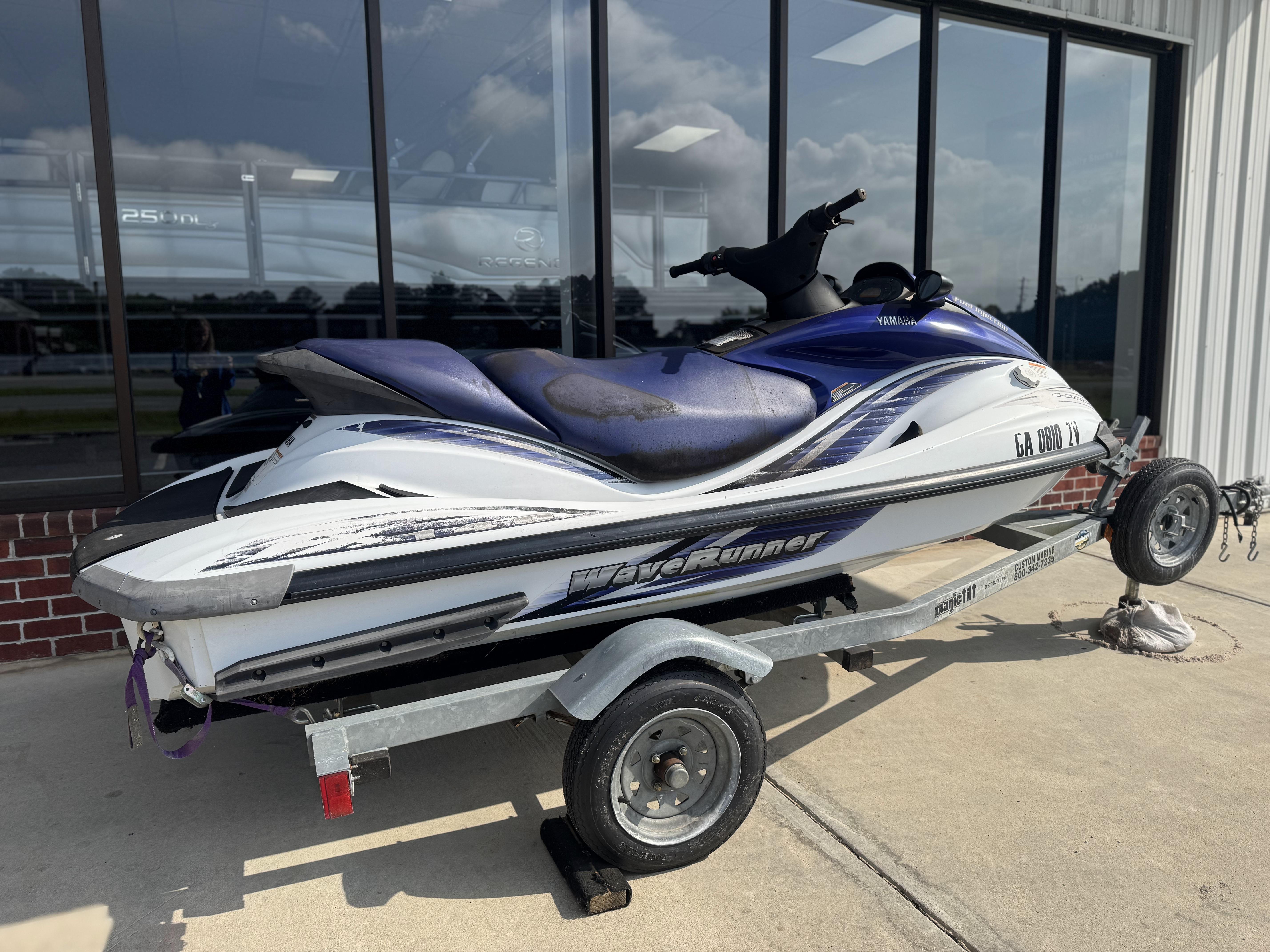 2003 Yamaha WaveRunner FX140 on trailer, parked outside a building.