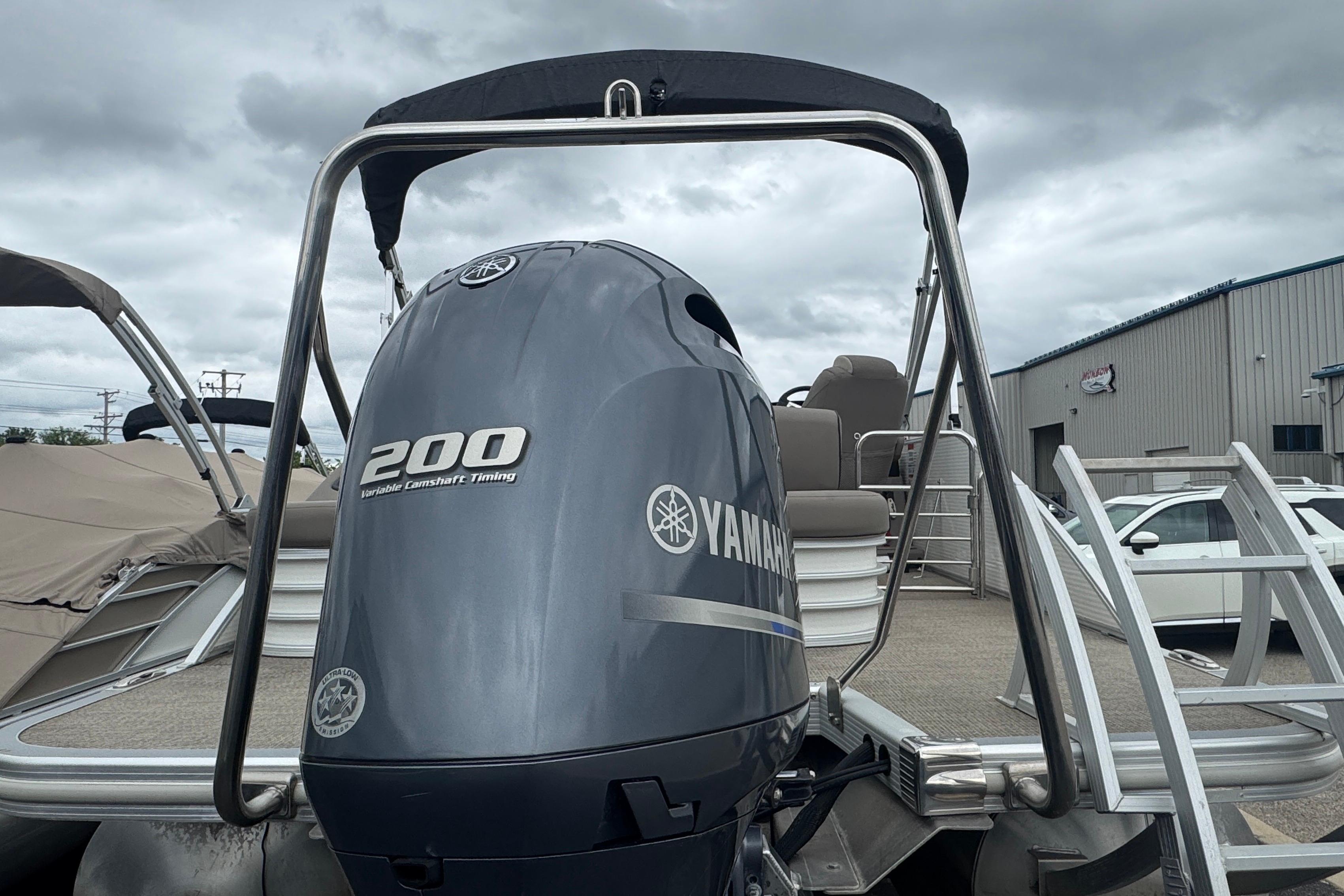 2019 Bennington SX 22 SSBXP pontoon boat with Yamaha 200 engine, docked under cloudy skies.