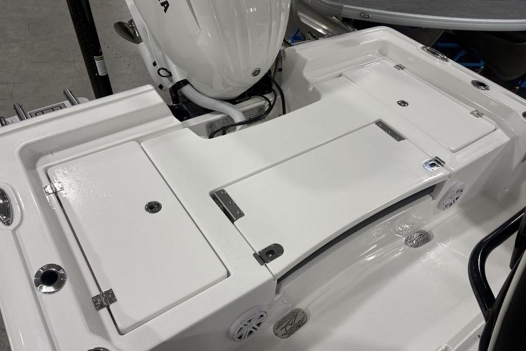 2026 Tidewater 2300 Carolina Bay boat deck with storage compartments and motor.