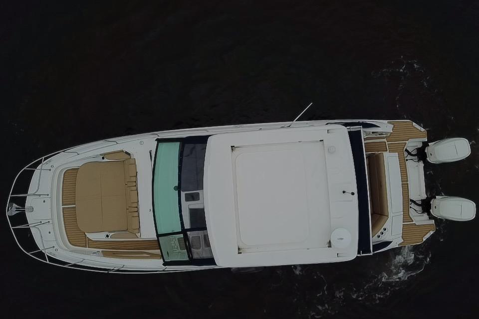 Aerial view of 2021 Sea Ray Sundancer 320 Outboard boat on water.