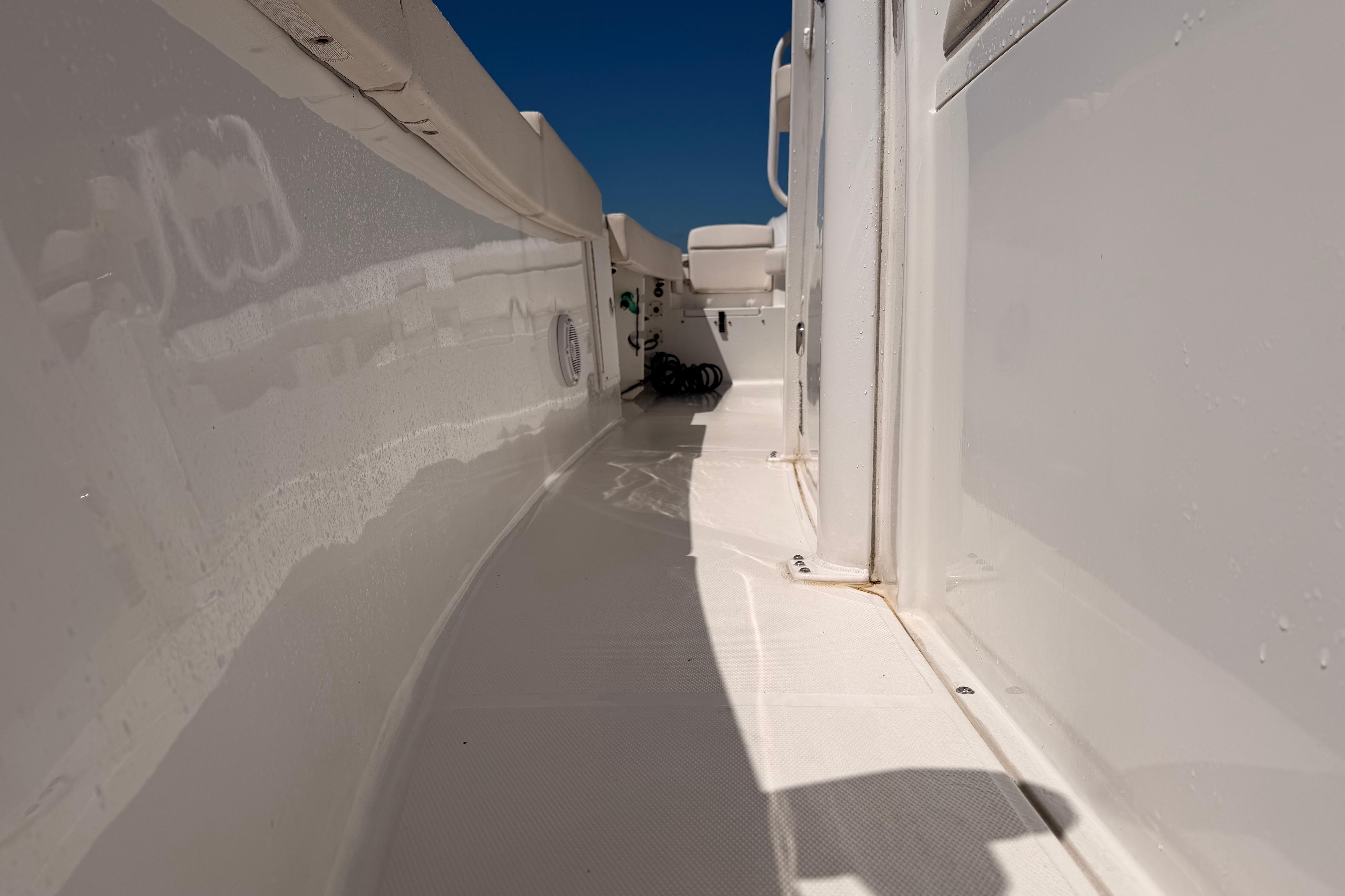 2024 Sea Hunt Gamefish 27 Coffin Box boat deck, white interior, sunny day.