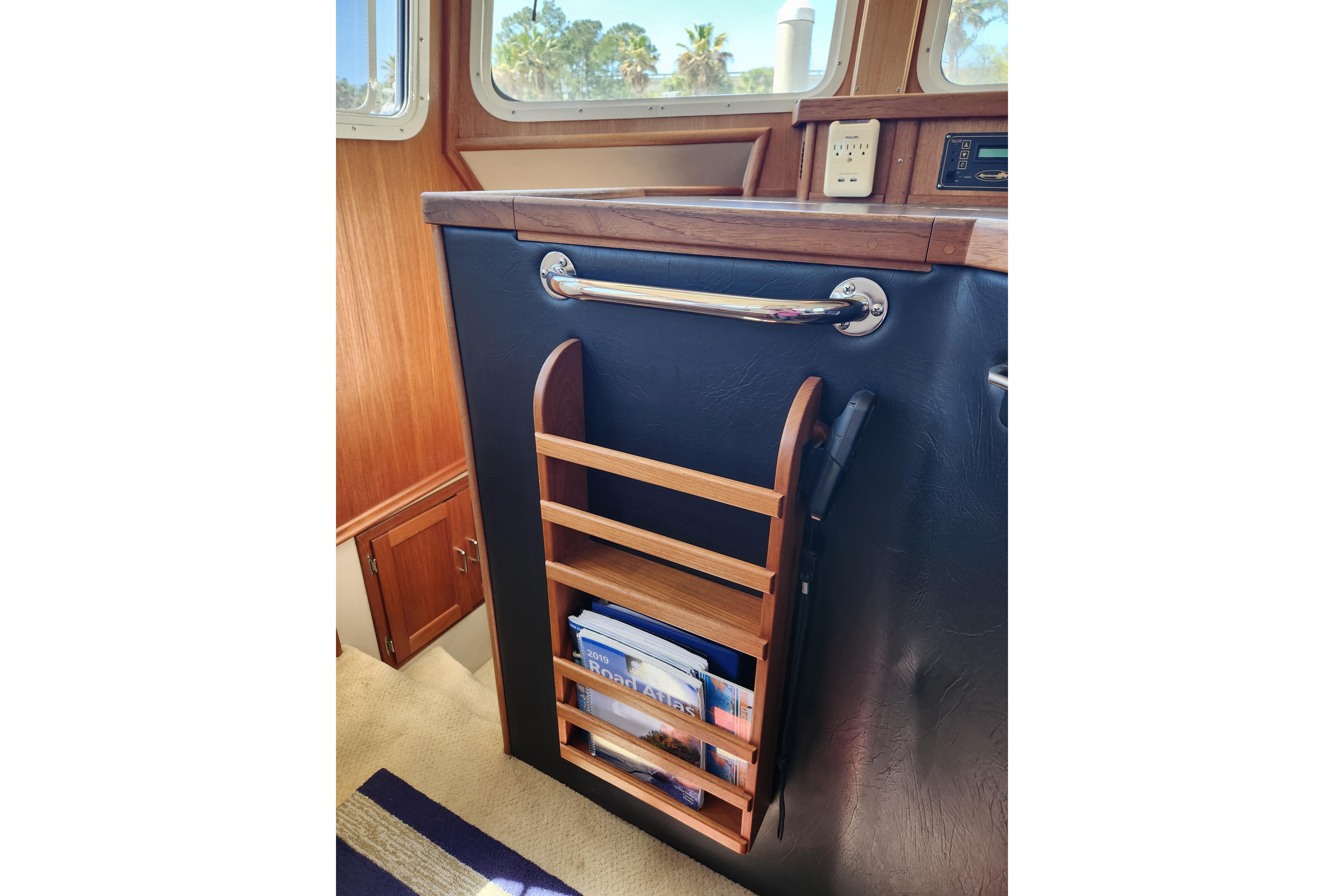 Interior of 2006 American Tug AT with wooden magazine rack and grab handle.