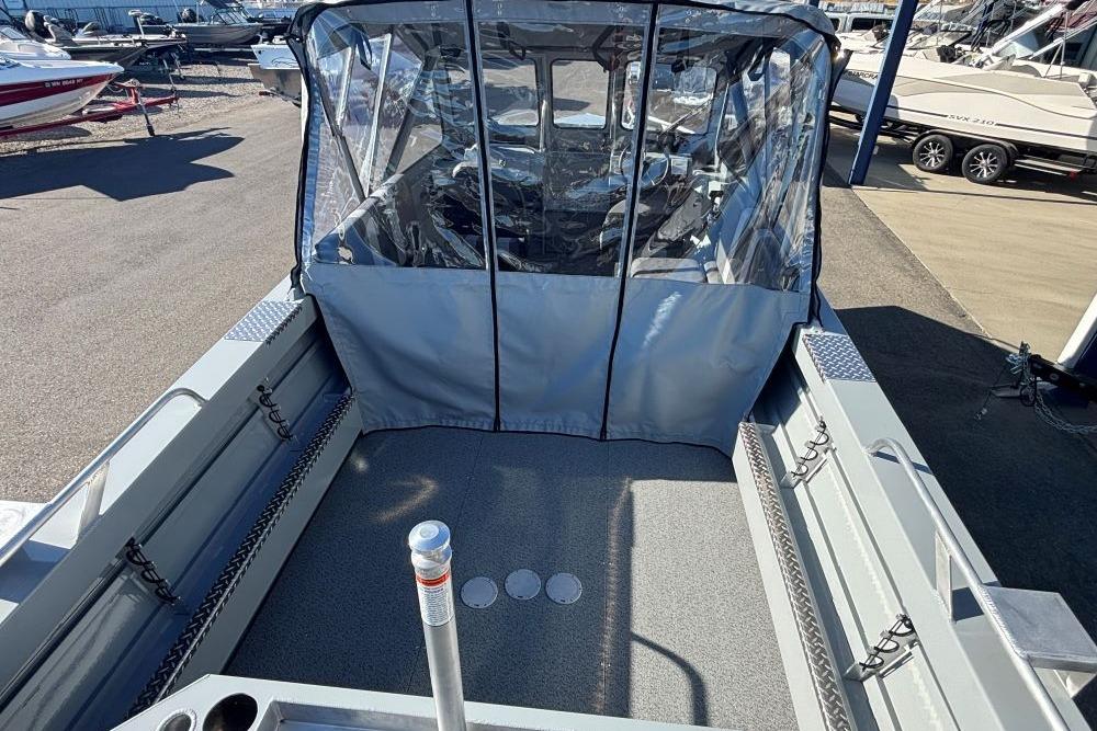 2025 Hewescraft 200 ProV ET boat with covered cockpit, docked at marina.