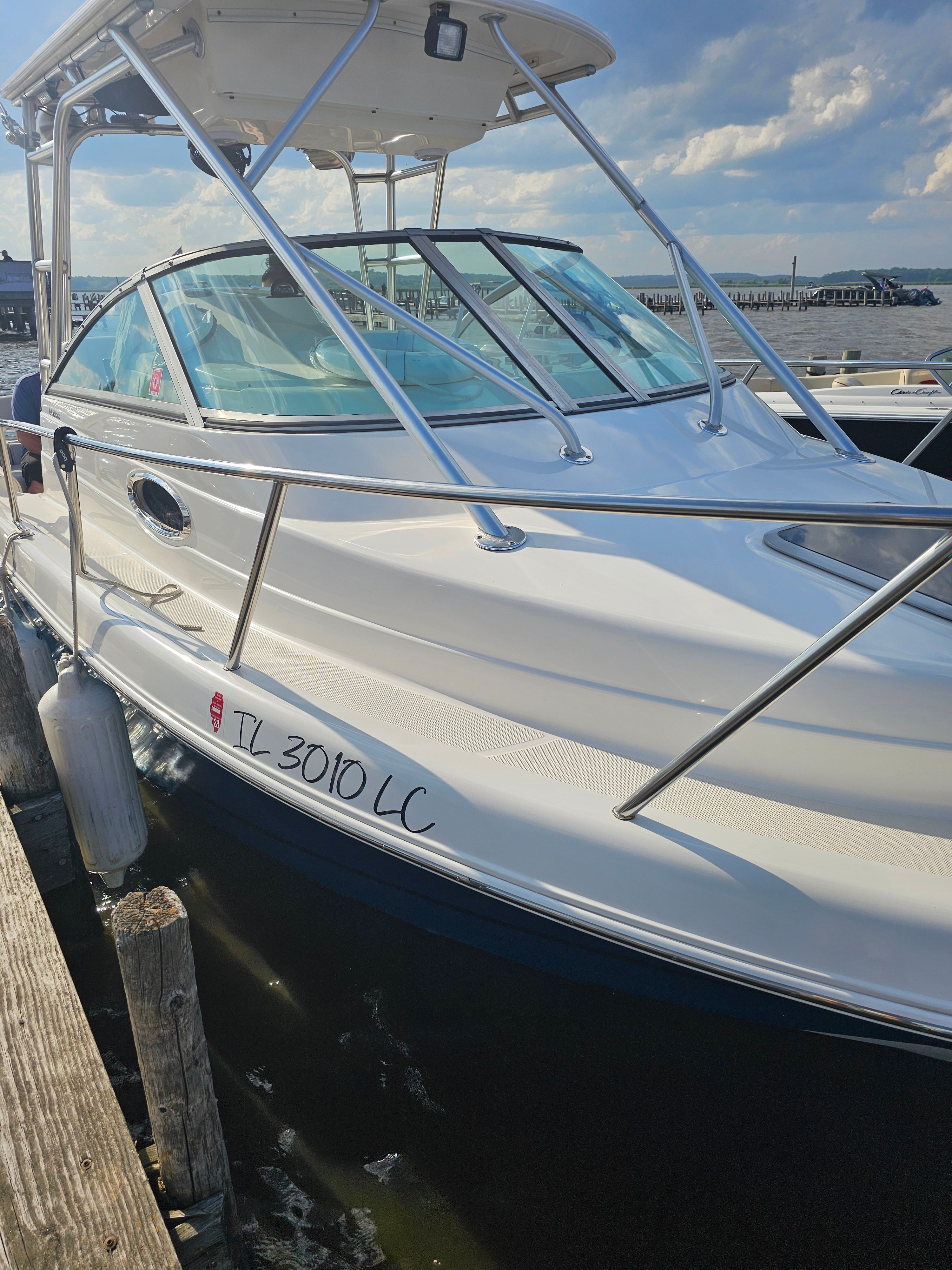 2005 Robalo R265 Walkaround boat docked on a sunny day.