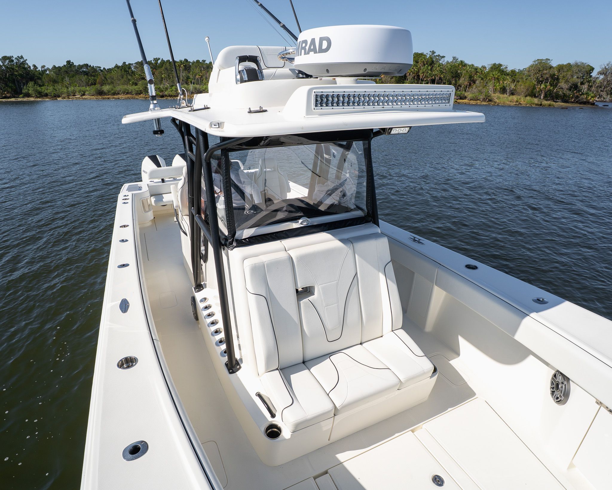 A 2022 SeaVee 370Z boat on the water with white seating area and radar equipment.