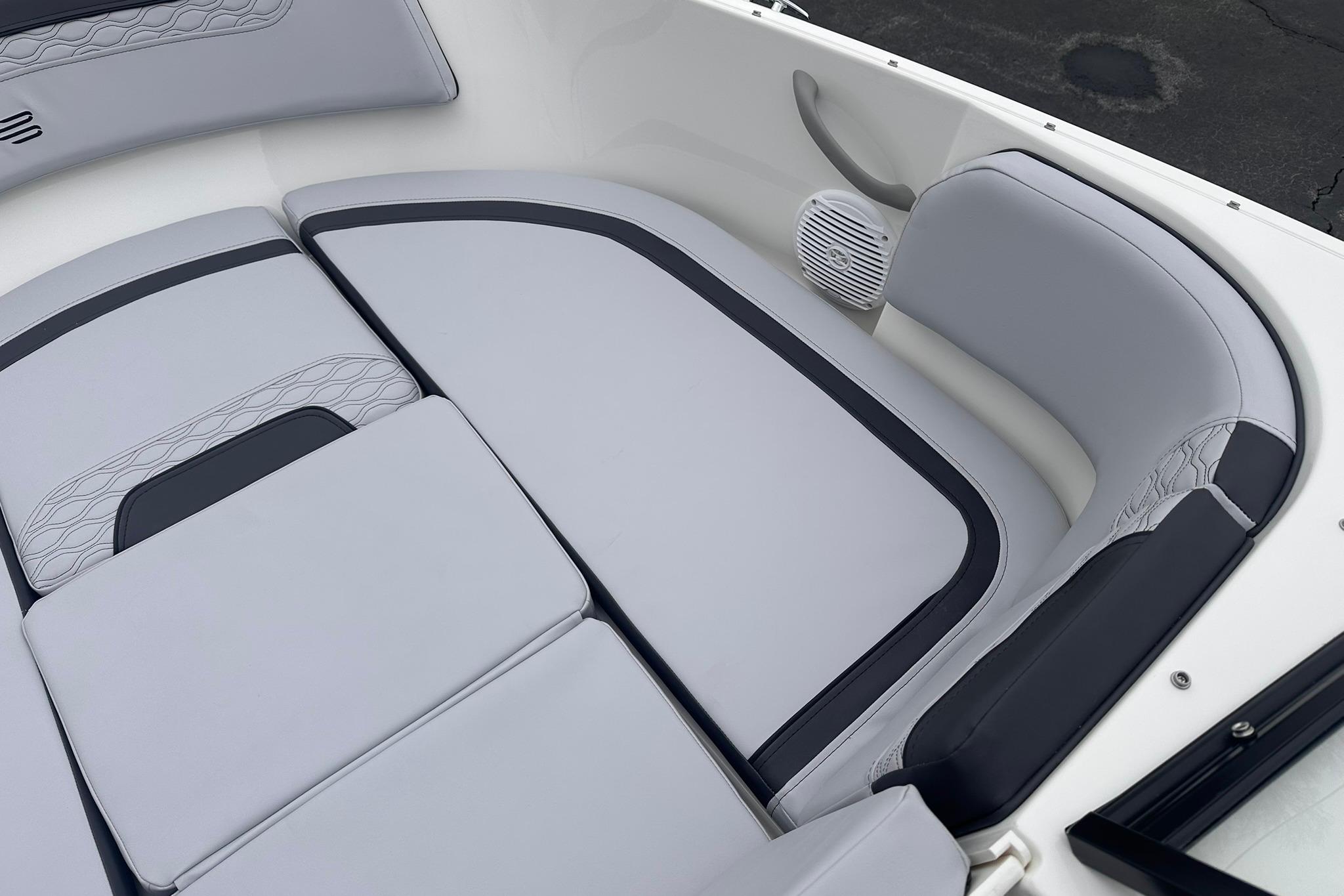 2026 Bayliner M17 boat interior with sleek gray seating and integrated speaker.
