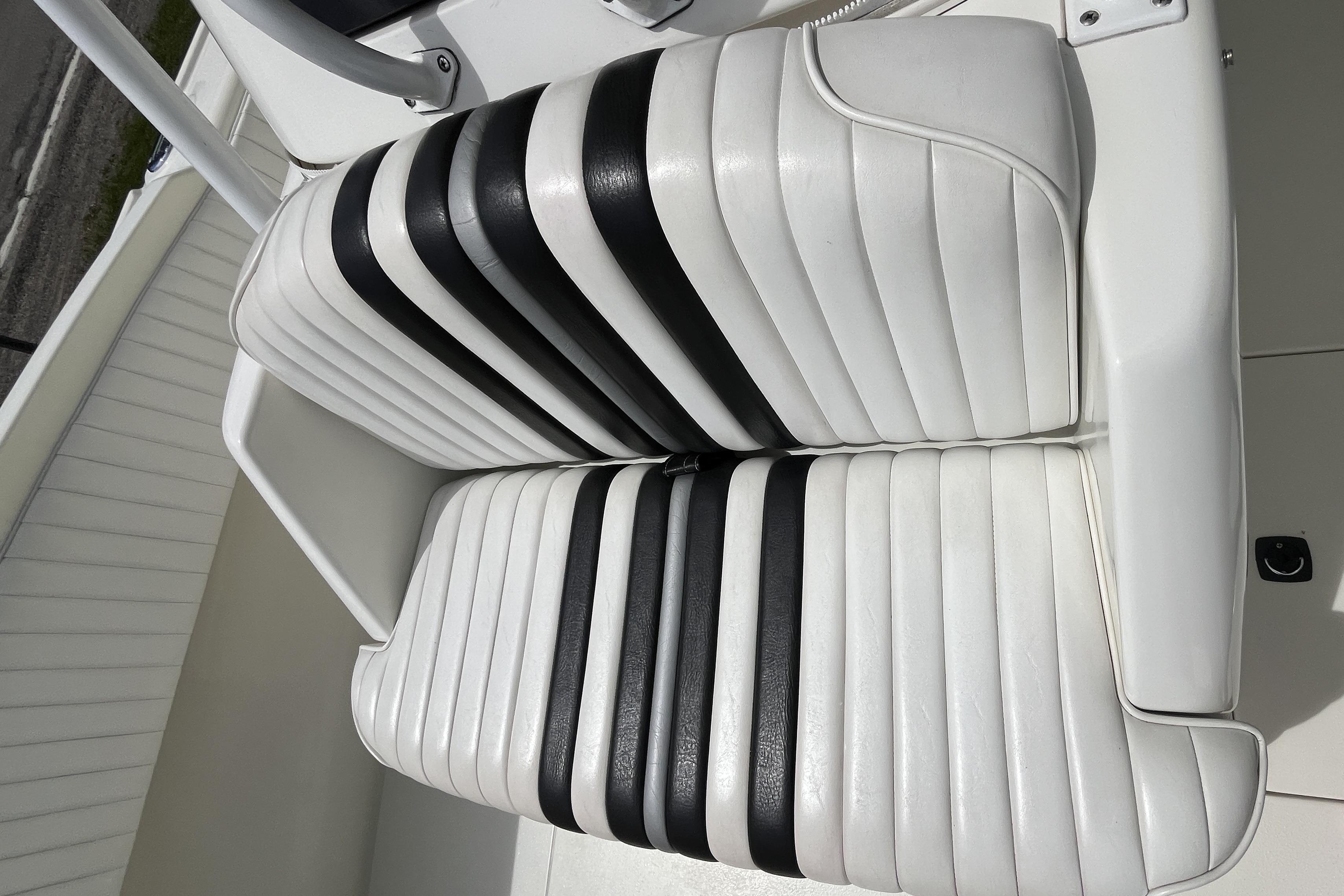 White and black striped seating on a 1994 Intrepid 30 Open Cuddy boat.