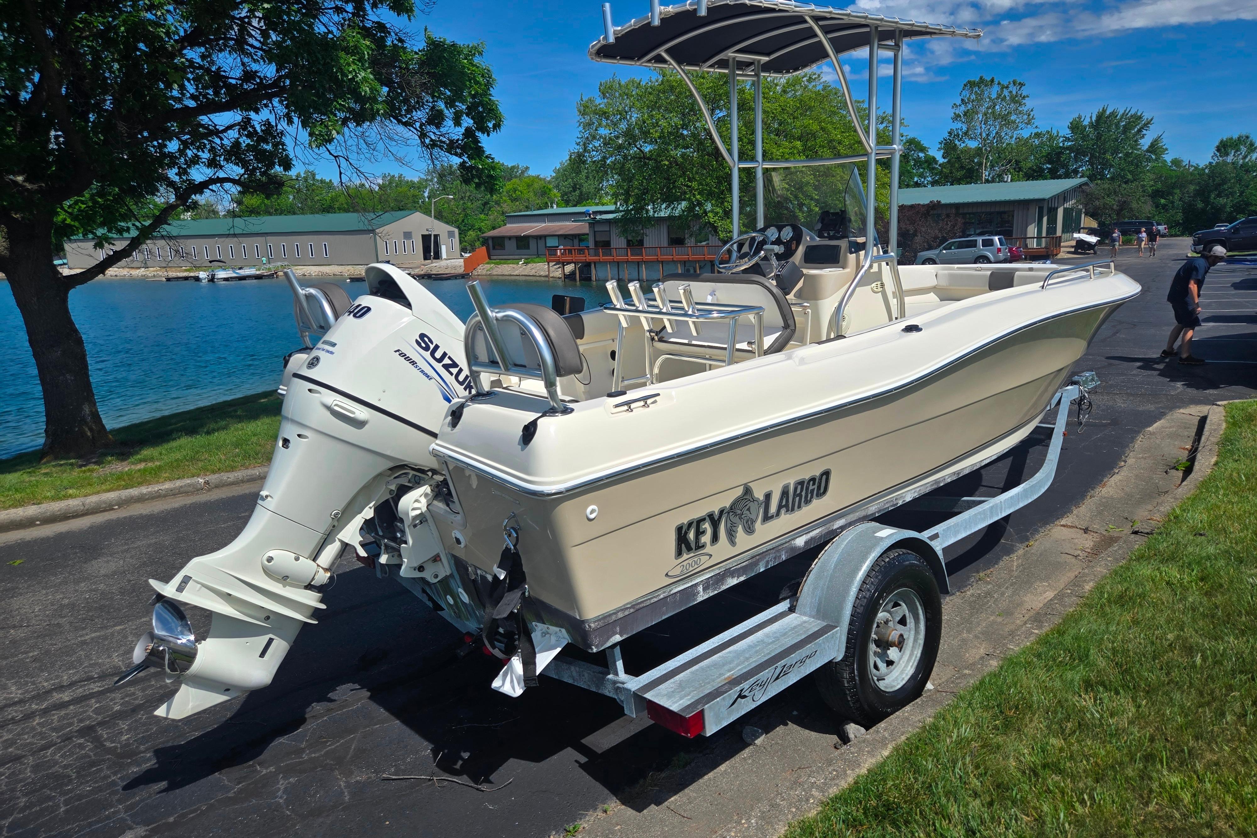 2016 Key Largo 2000CC boat on trailer, parked near a scenic waterfront.