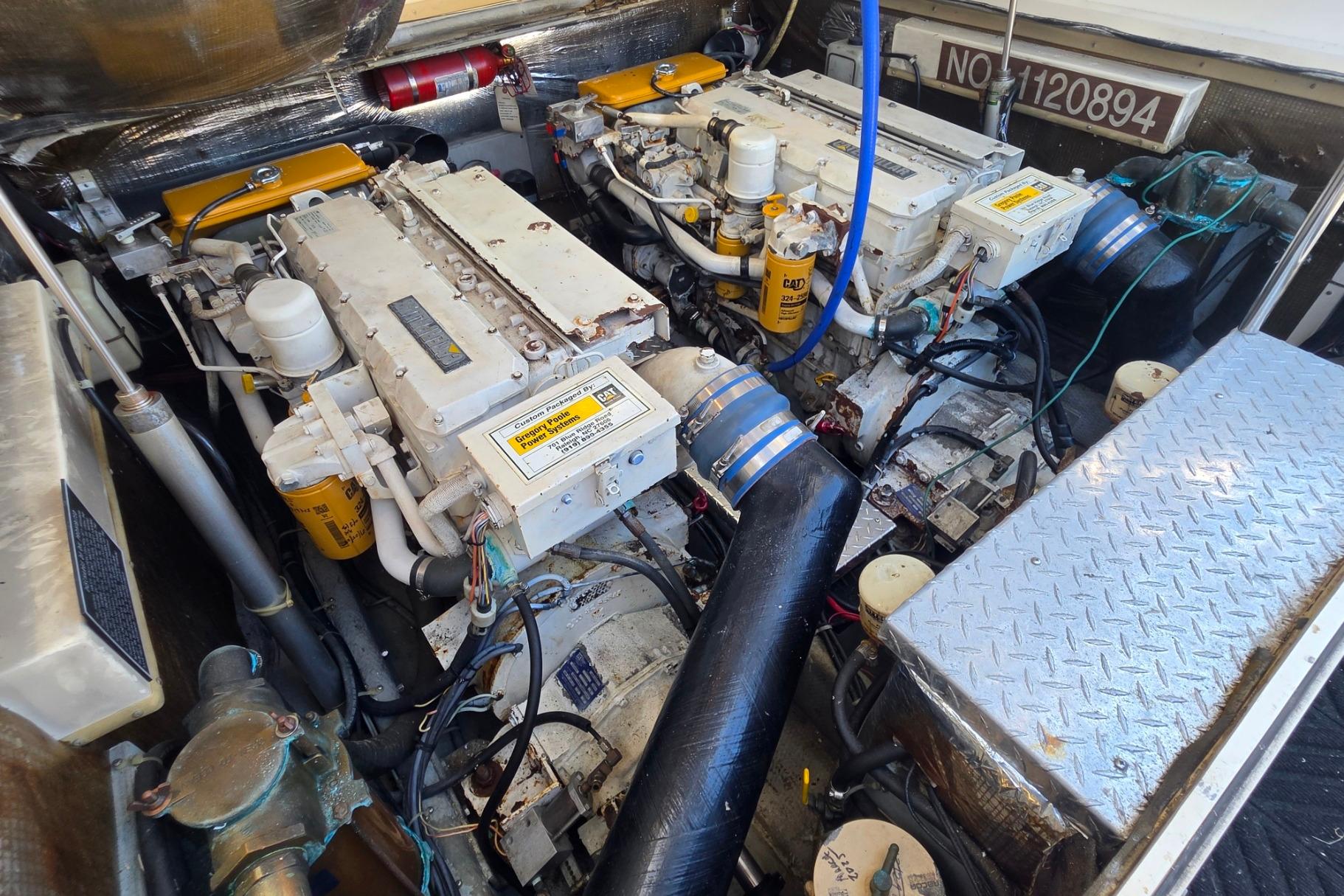 Engine compartment of a 1999 Albemarle 305 Express Fisherman boat, featuring dual engines.