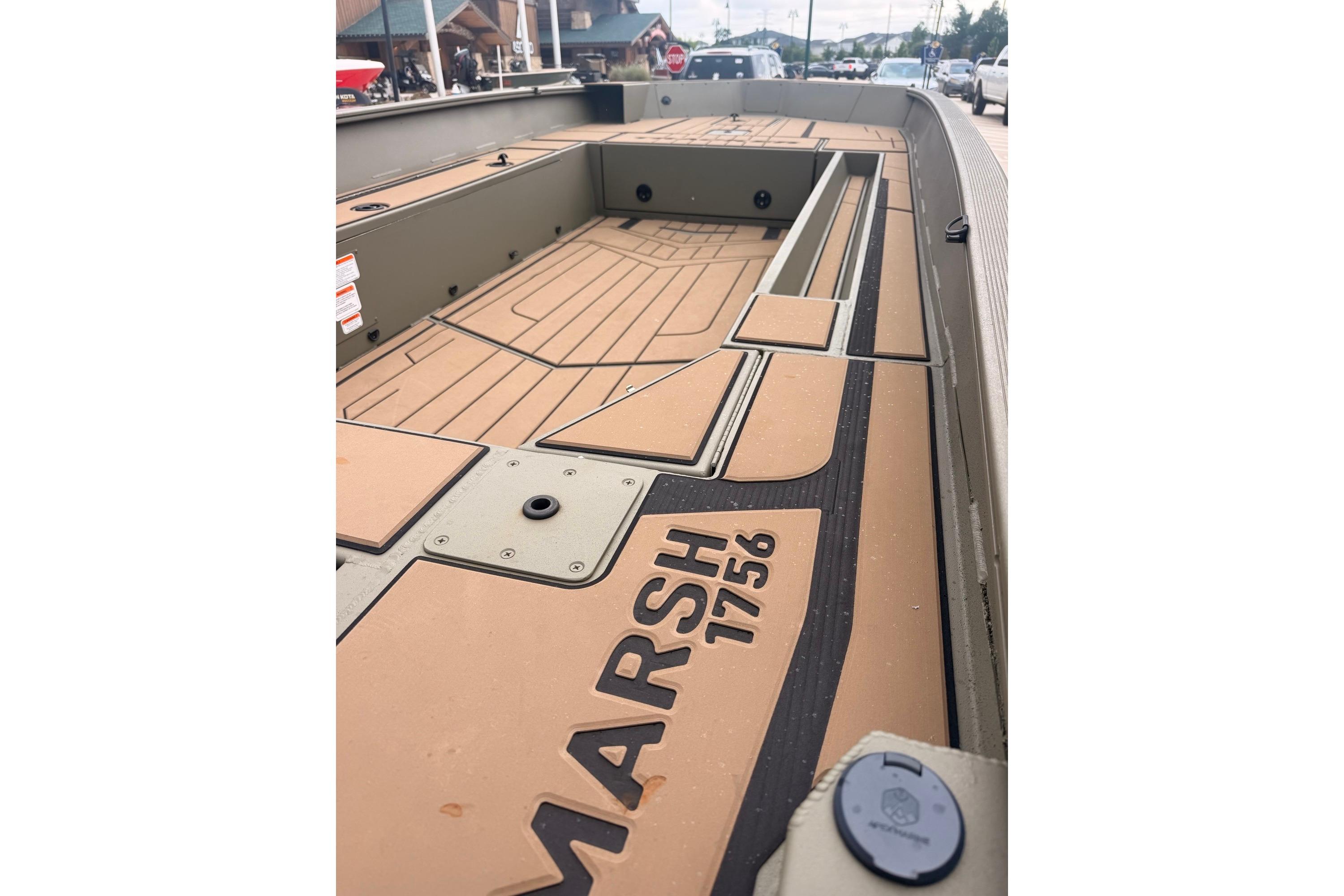 2026 Tracker Grizzly 1756 MARSH boat interior with tan deck and black accents.